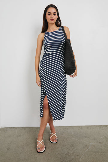 Max Wrap Dress with a Scoop Neck, Sleeveless, Gathering at Side Seam and Front Slit in Navy and White Nautical Stripe Colorway. Front View Shown on Model.