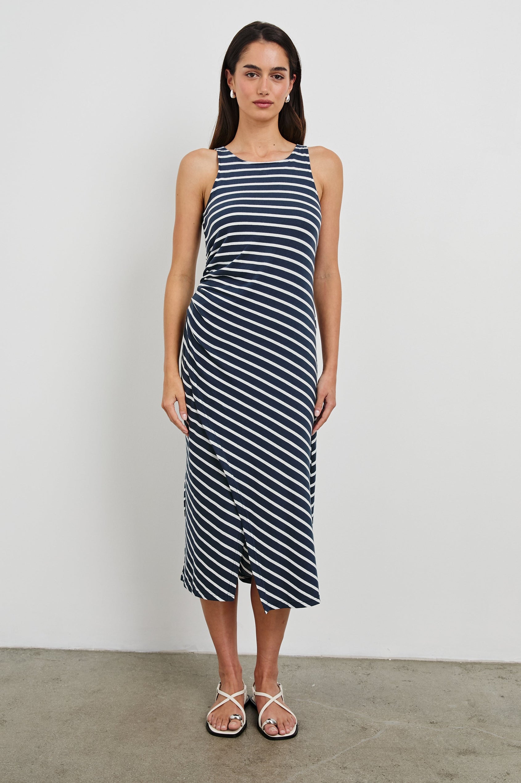Max Wrap Dress with a Scoop Neck, Sleeveless, Gathering at Side Seam and Front Slit in Navy and White Nautical Stripe Colorway. Front View Shown on Model.