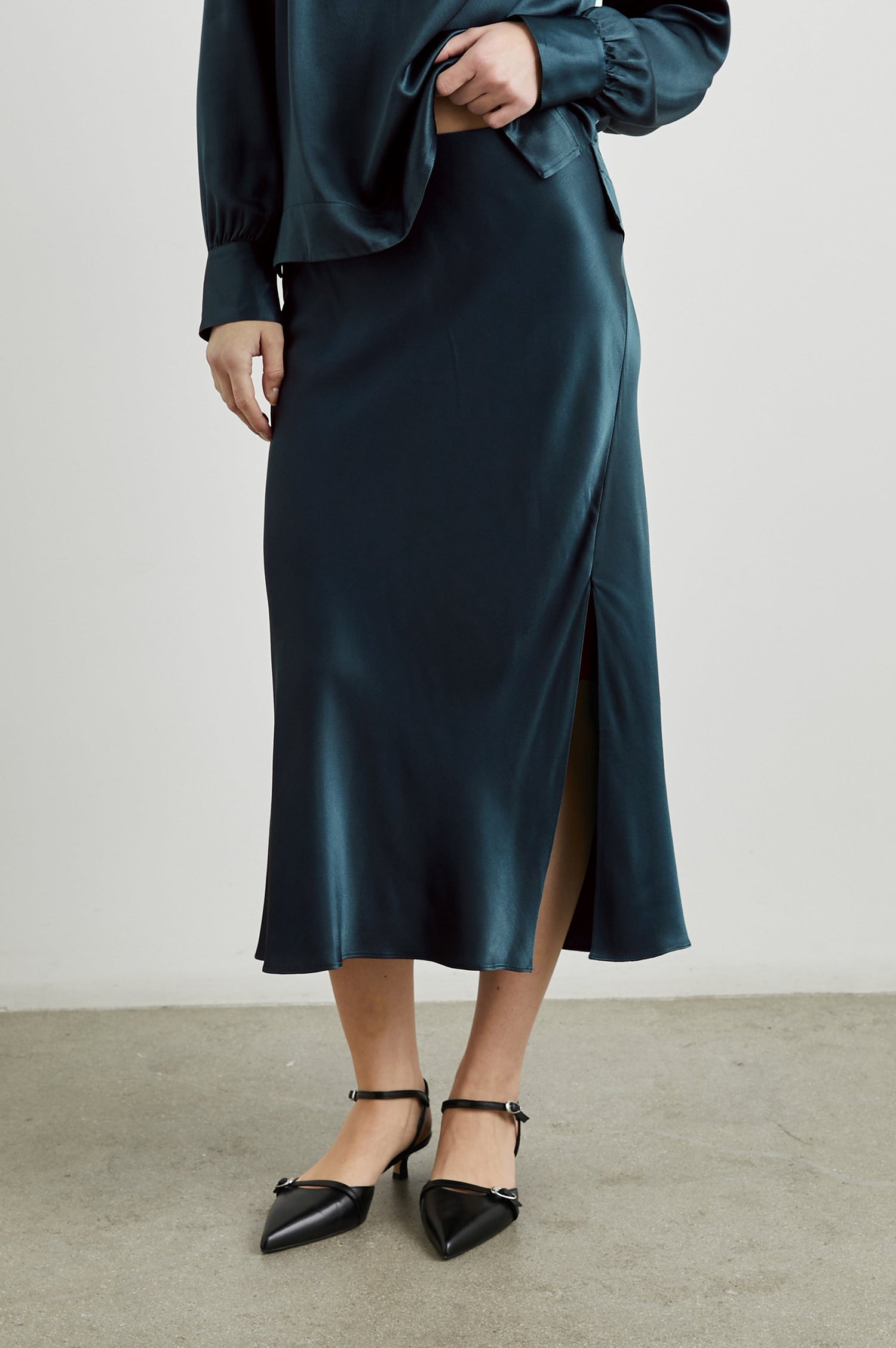 Maya Midi Skirt with Mid-Thigh Side Slit in Deep Sea Colorway - Front View Featured on Model