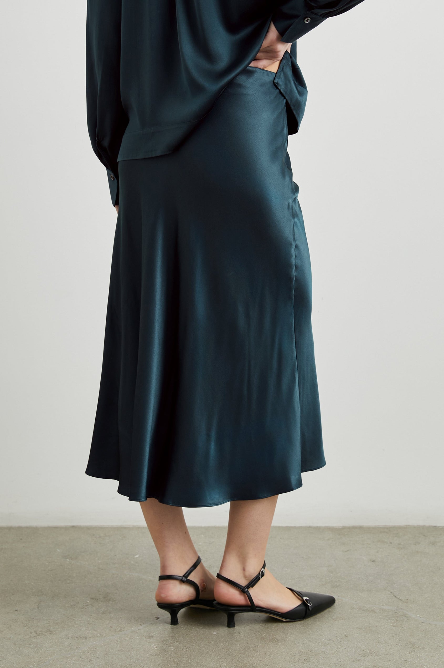 Maya Midi Skirt with Mid-Thigh Side Slit in Deep Sea Colorway - Back View Featured on Model