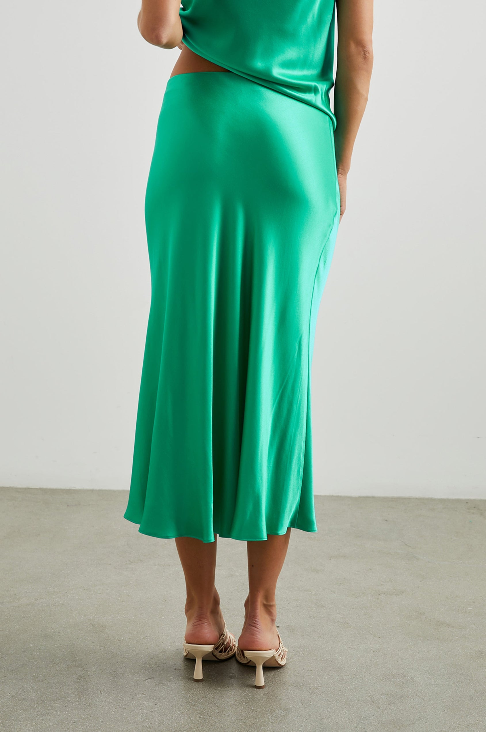Maya Midi Skirt with Mid-Thigh Side Slit in Jade Colorway - Back View Featured on Model