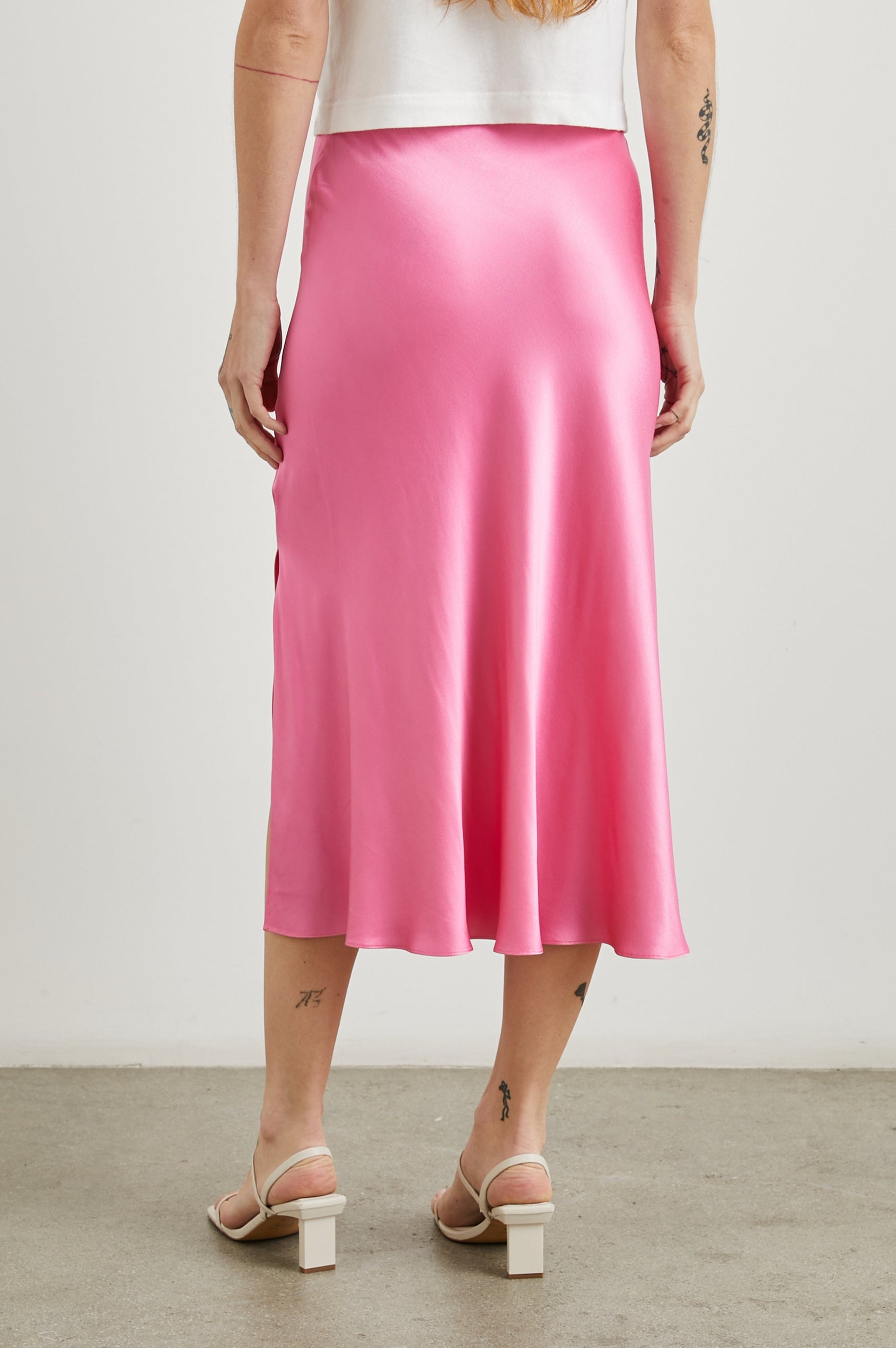 Maya Midi Skirt with Mid-Thigh Side Slit in Malibu Pink Colorway - Back View Featured on Model