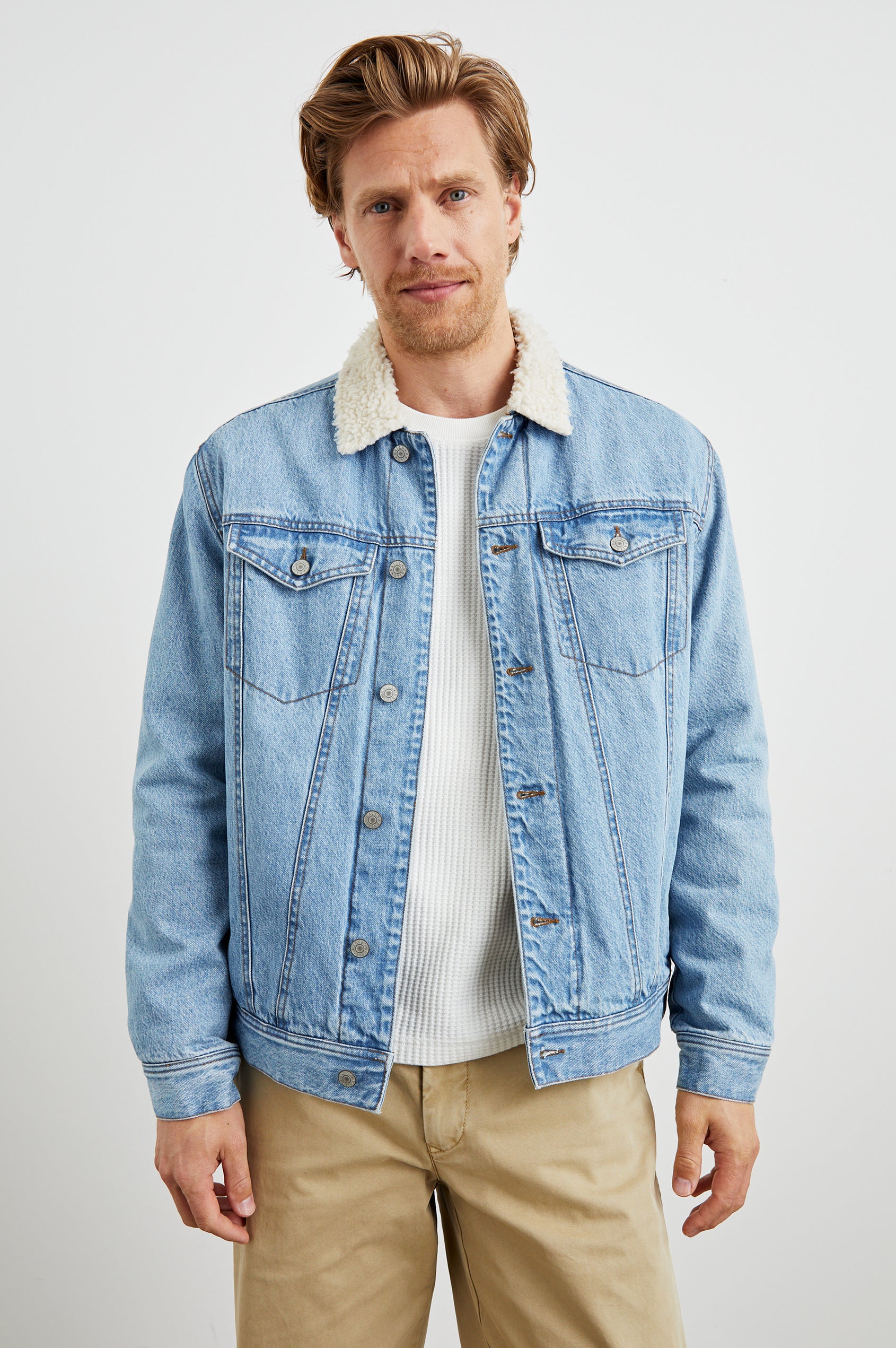 McKinley Denim Jacket with Button Closure, Two Chest Button Flap Pockets and a Cream Faux Sherpa Collar in Vintage Wash Colorway - Front View Featured on Model