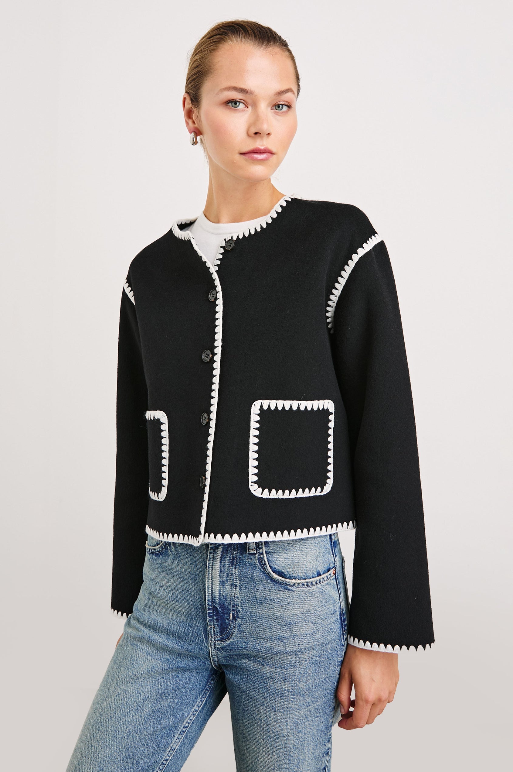 Melanie Jacket with Button Closure and Two Front Patch Pockets in Black Colorway, with White Stitching along the Trim and Pockets - Front View Featured on Model