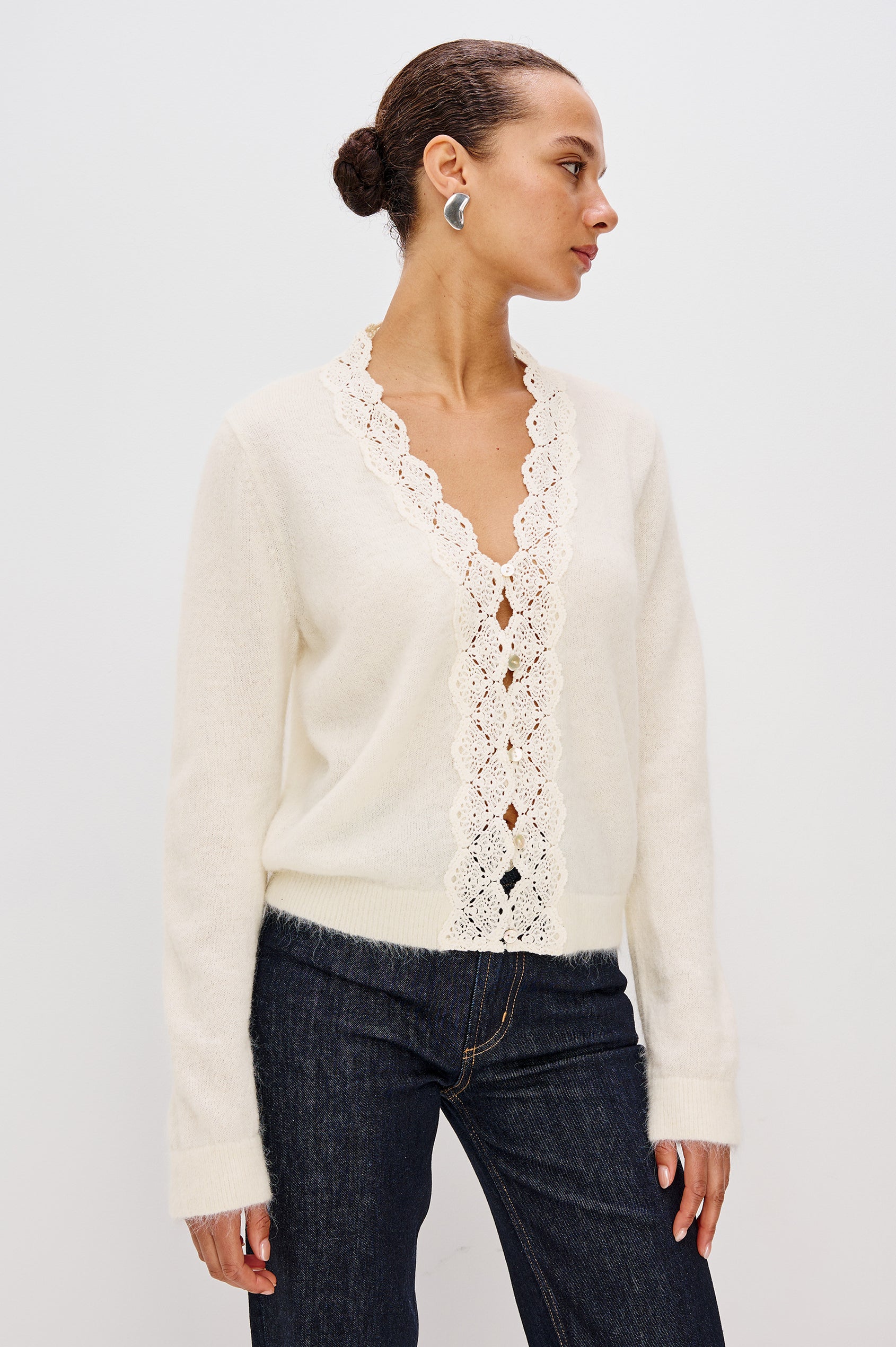 Knitted from a soft alpaca-wool blend, the Mer features a flattering V-neckline trimmed with delicate lace extending to the hem. With front button closures and long sleeves. Front Crop View featured on Model.