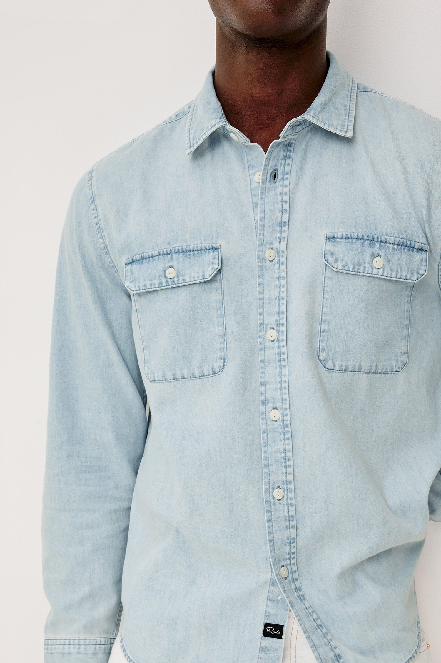 Meyer Shirt in Denim With Collar, Long Sleeves, and Chest Buttoned Flap Pockets in Light Vintage Wash - Upper Body Front Detail View Featured on Model