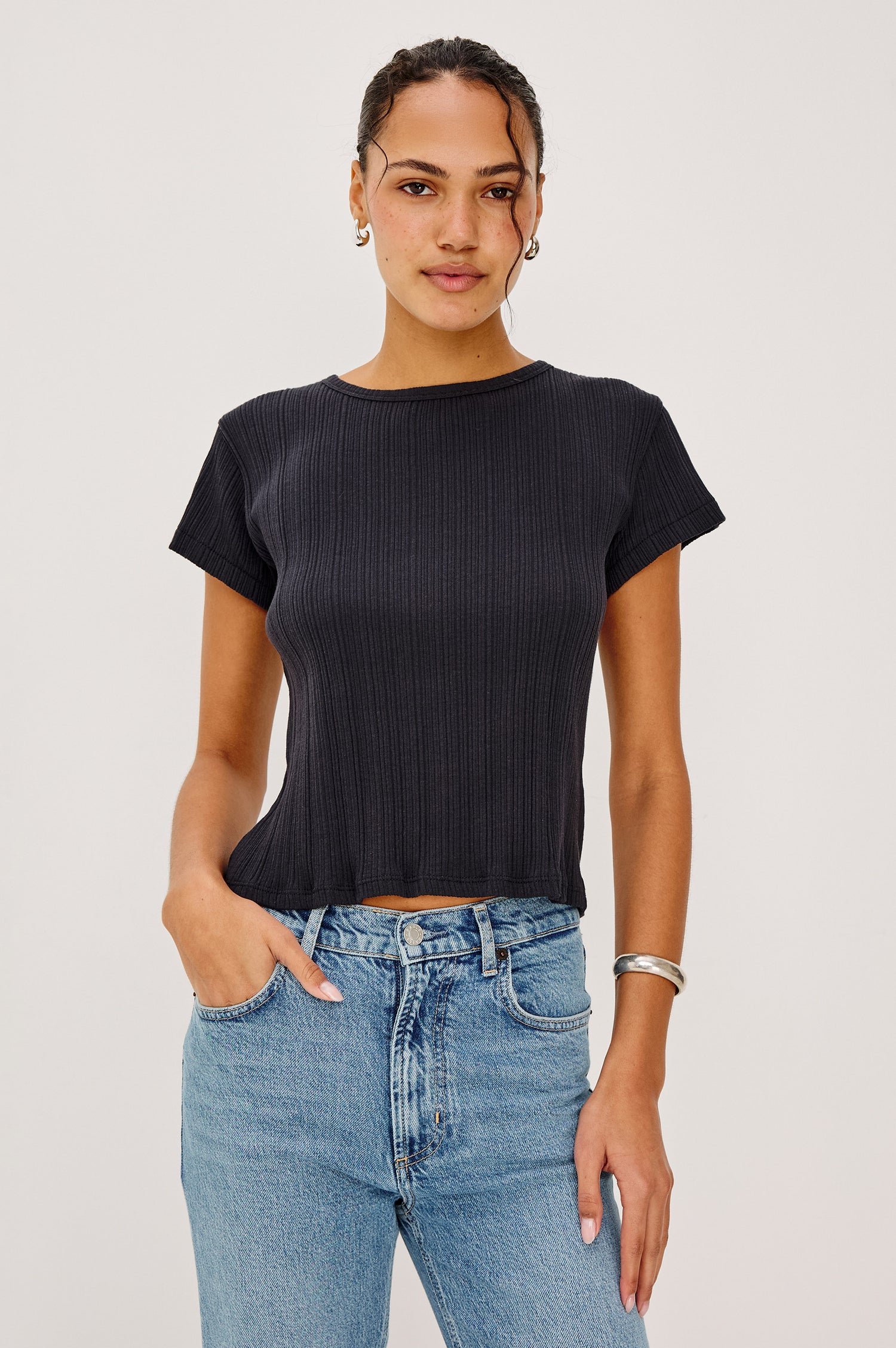 Mickey Fitted Crewneck Short Sleeve Baby Tee With Pleated Rib Pointelle Detailing in Black Colorway - Upper Body Front View Stylized Featuerd on Model