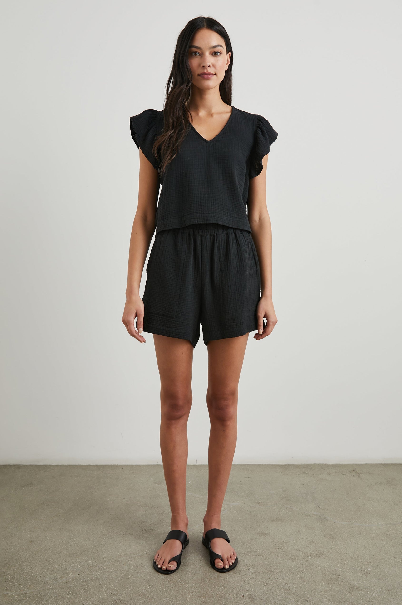 Miley Cropped, Short-Sleeve, V Neck Top with Flutter Sleeves and Textured Fabric in Black Colorway - Front Full Body View Featured on Model