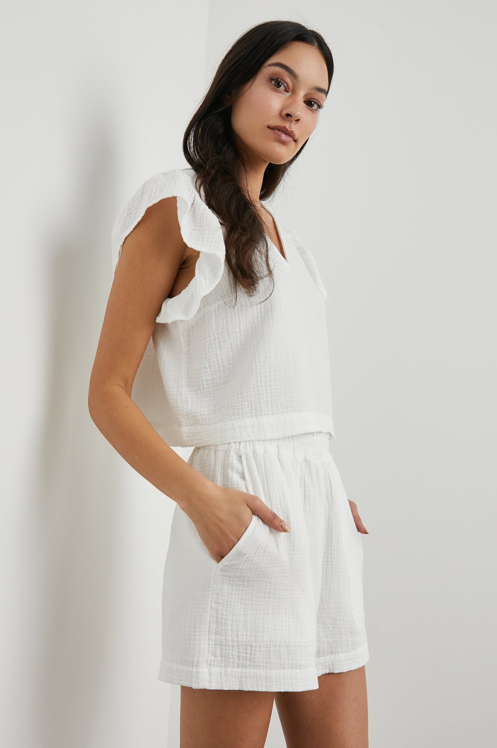 Miley Cropped, Short-Sleeve, V Neck Top with Flutter Sleeves and Textured Fabric in White Colorway - Side View Featured on Model