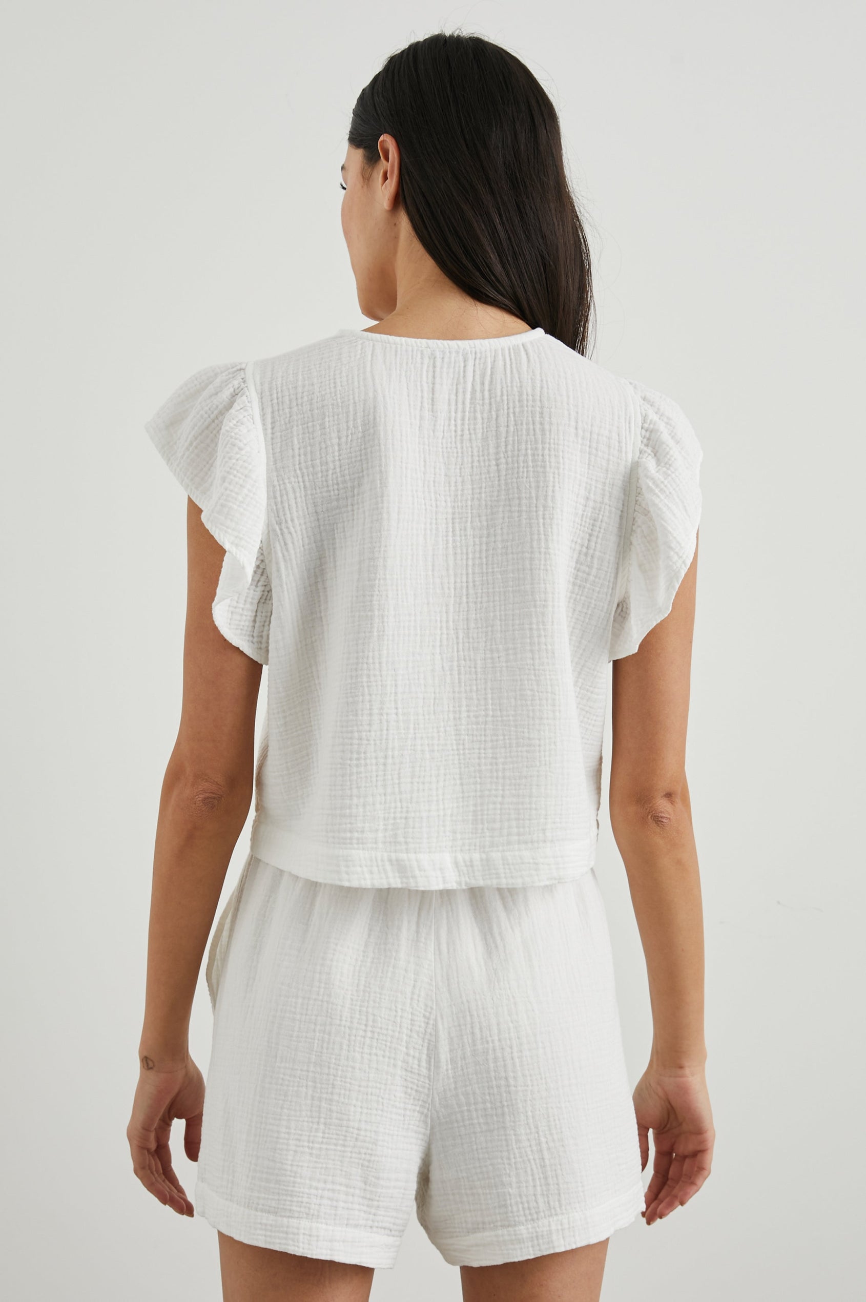 Miley Cropped, Short-Sleeve, V Neck Top with Flutter Sleeves and Textured Fabric in White Colorway - Back View Featured on Model