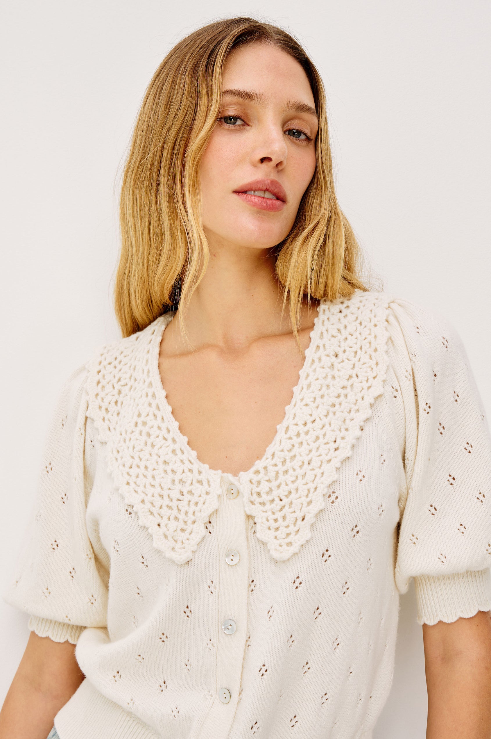 Mindy Cardigan Top in Cotton Wool Blend With Crochet Peter Pan Collar, Short Puff Sleeves, and Ribbed Trim in Ivory Colorway - Upper Body Front View Featured on Model