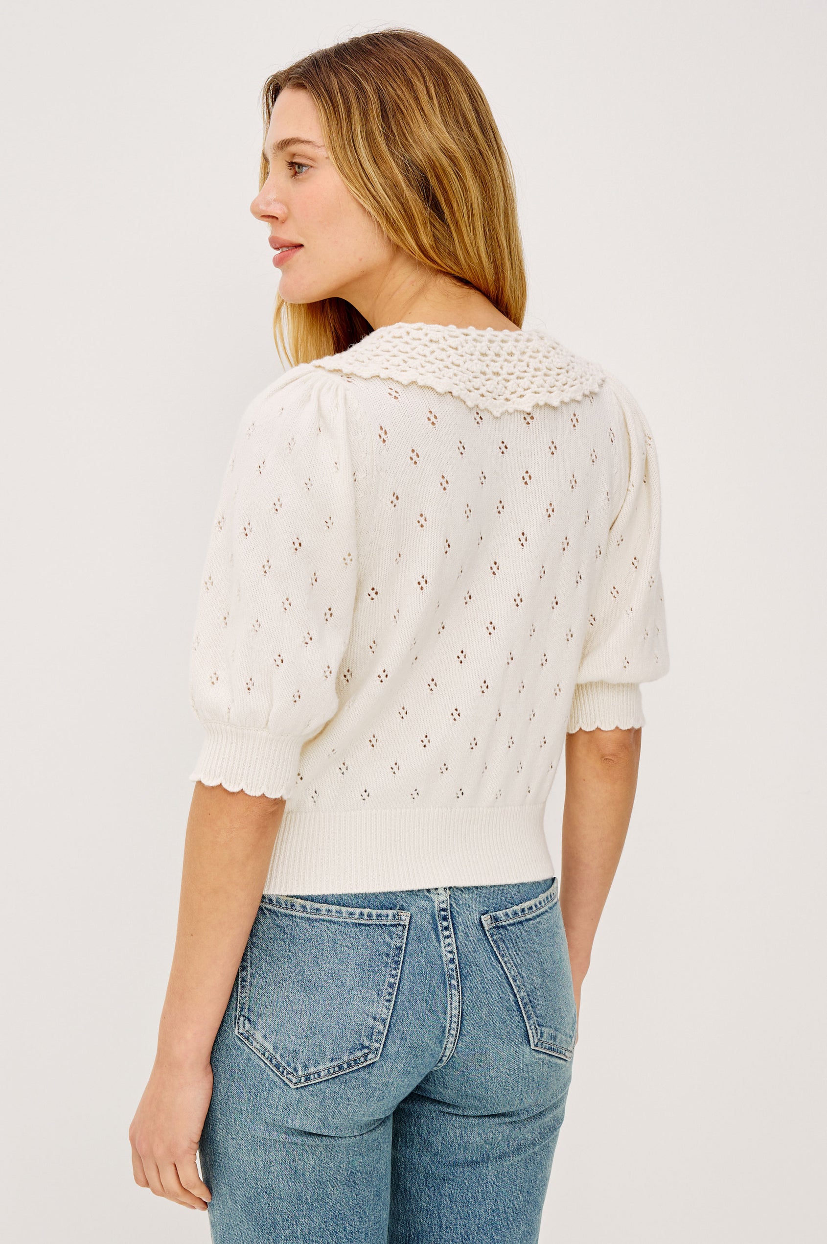 Mindy Cardigan Top in Cotton Wool Blend With Crochet Peter Pan Collar, Short Puff Sleeves, and Ribbed Trim in Ivory Colorway - Upper Body Back View Featured on Model