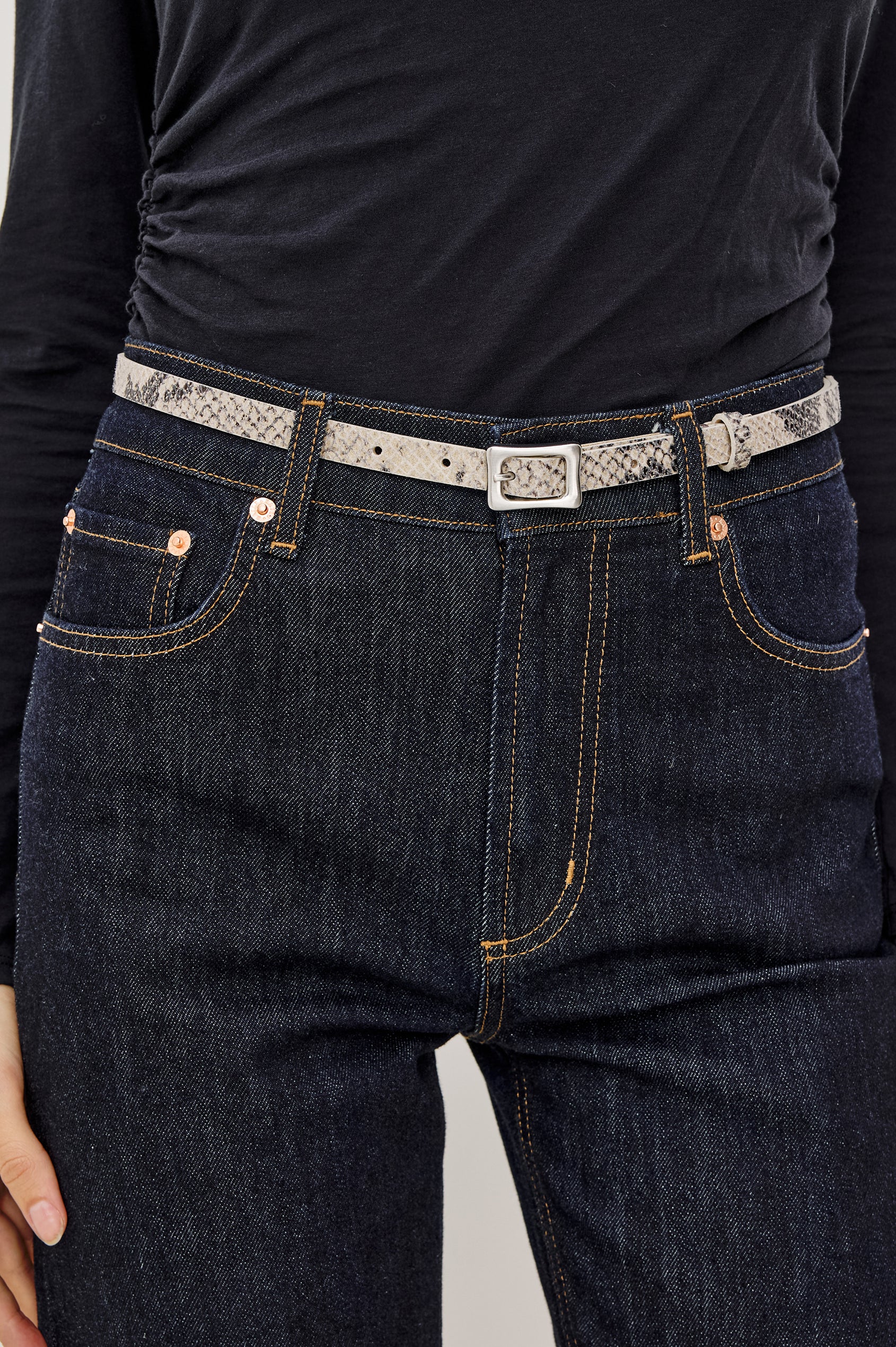 Remi Slim Leather Belt With Adjustable Buckle Closure in Ecru Python Colorway - Close Up Front Mid Body View Featured on Model