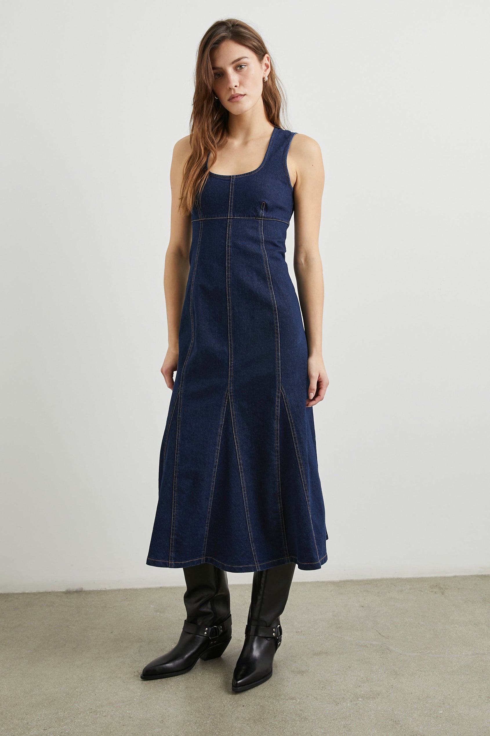 Minna Sleeveless Denim Midi Dress with Shoulder Straps, a Scoop Neck, Darting Details, and a Half Zippered Back in Rinse Indigo Colorway - Front Full Body View Featured on Model   