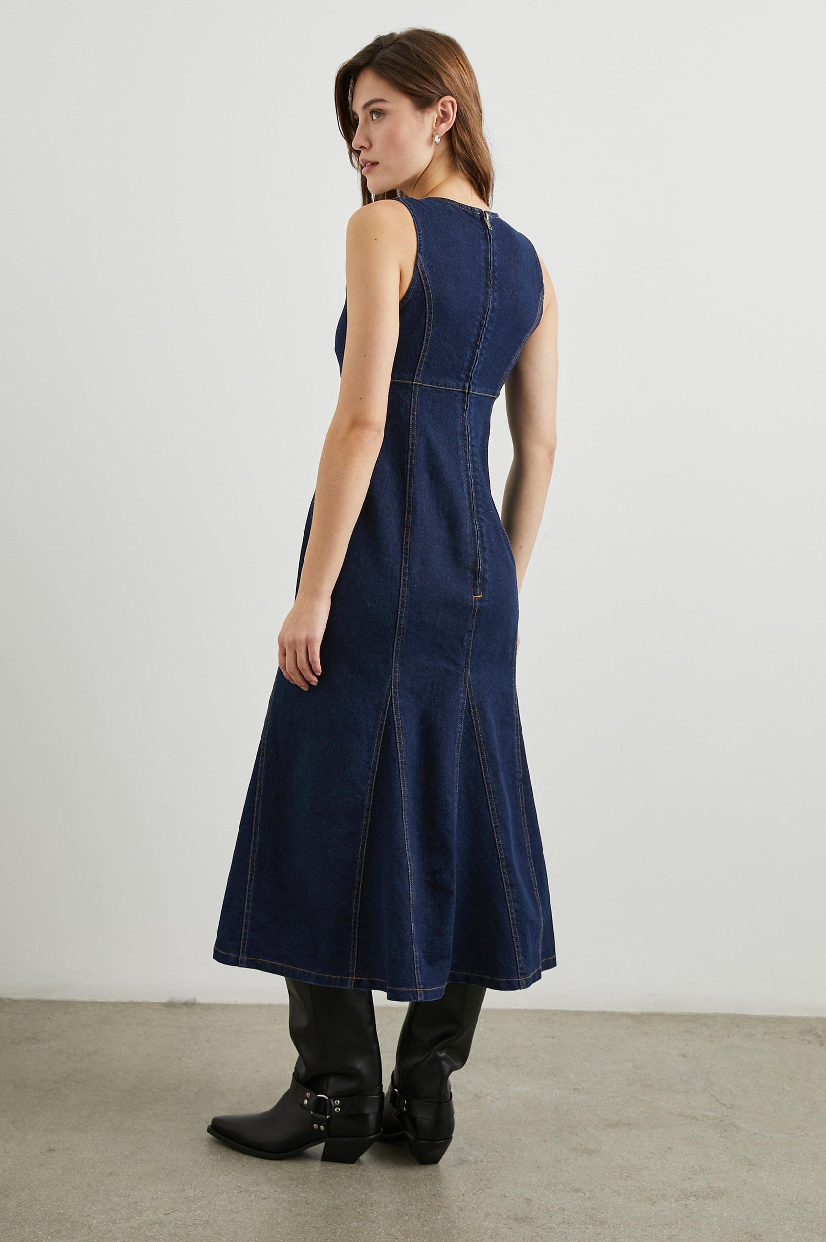 Minna Sleeveless Denim Midi Dress with Shoulder Straps, a Scoop Neck, Darting Details, and a Half Zippered Back in Rinse Indigo Colorway - Back Full Body View Featured on Model   