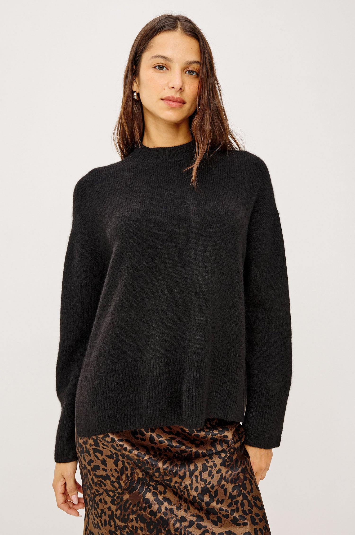 Miranda Long-Sleeve Sweater with a Mock Neck, Side Slits, and Ribbed Trim in Black Colorway - Front View Featured on Model