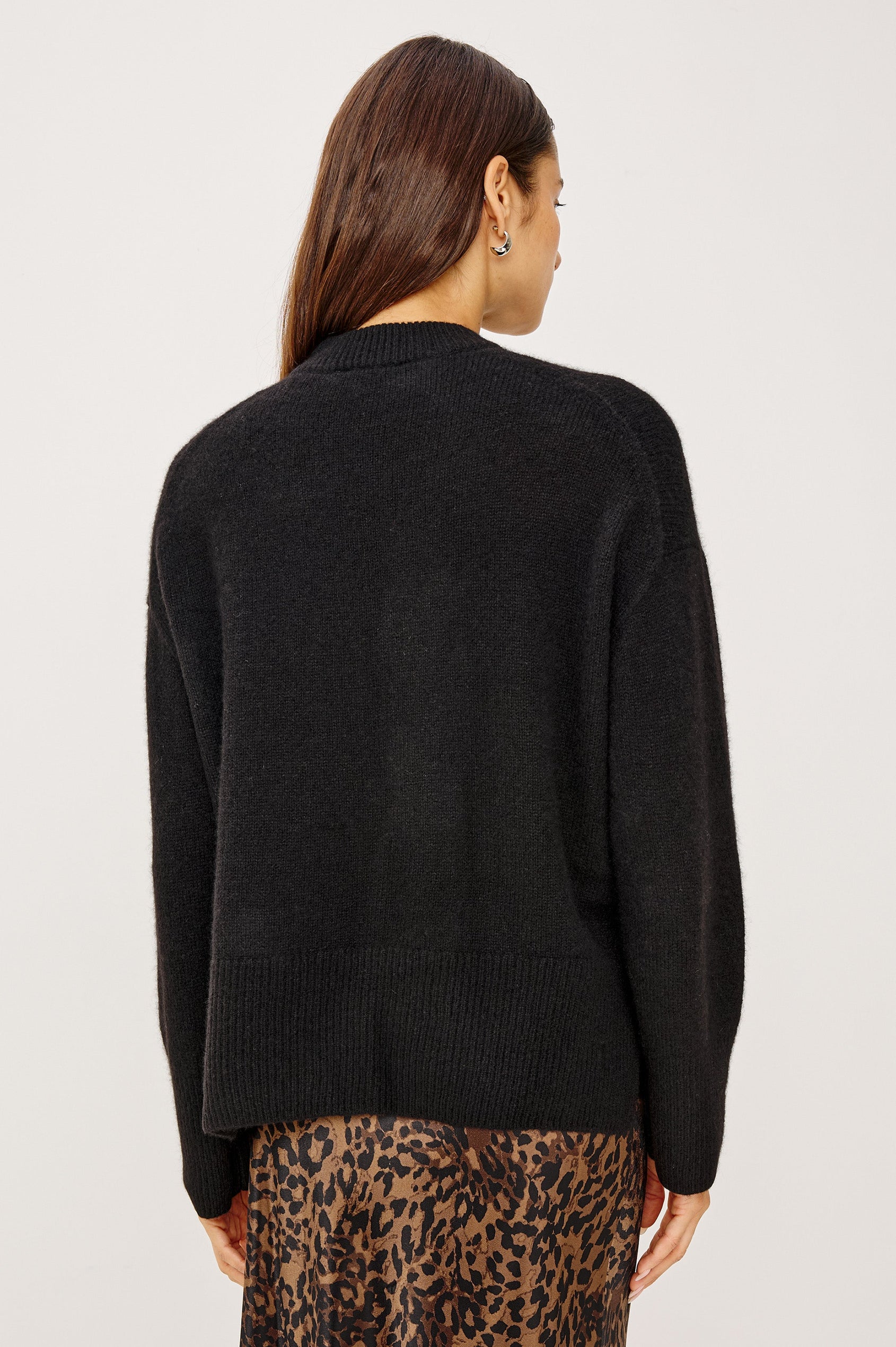 Miranda Long-Sleeve Sweater with a Mock Neck, Side Slits, and Ribbed Trim in Black Colorway - Back View Featured on Model