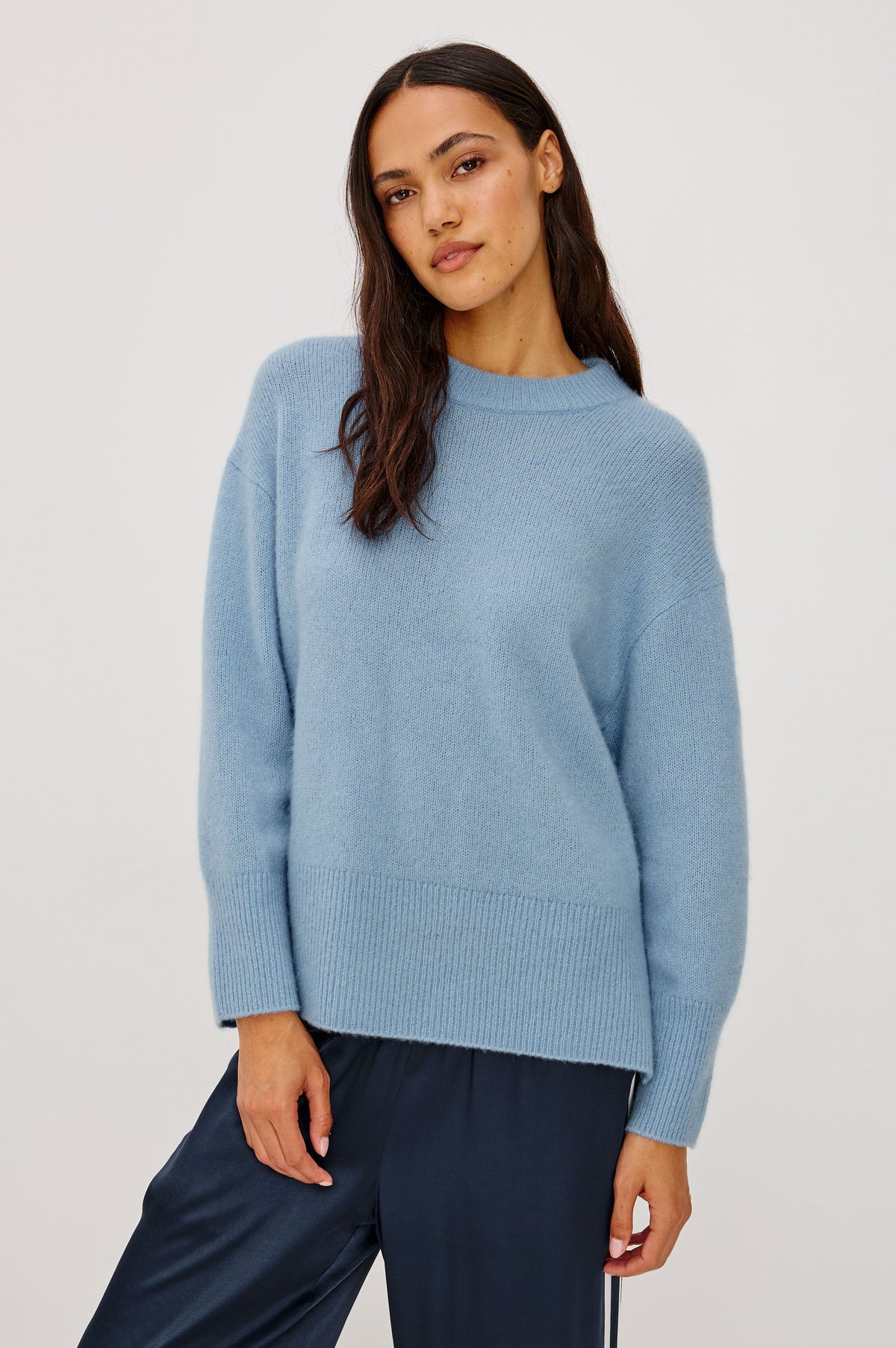 Miranda Sweater in Cashmere-Silk Blend With Relaxed Boxy Fit, Mock Neck, Drop Shoulders, and Side Slits at Hem in Fjord Blue Colorway - Upper Body Front View Featured on Model.