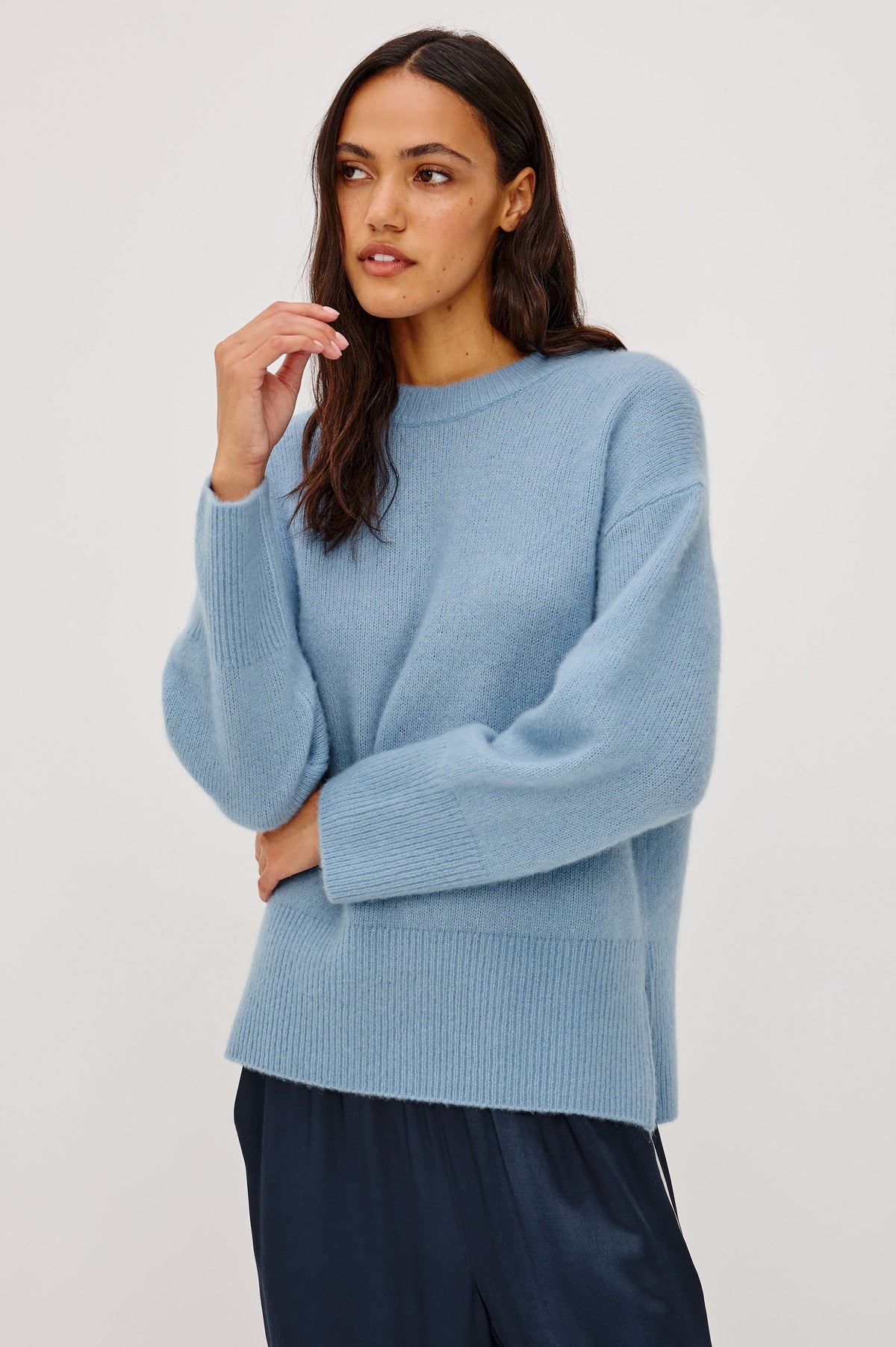 Miranda Sweater in Cashmere-Silk Blend With Relaxed Boxy Fit, Mock Neck, Drop Shoulders, and Side Slits at Hem in Fjord Blue Colorway - Front View Featured on Model.