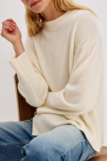 Miranda Long-Sleeve Sweater with a Mock Neck, Side Slits, and Ribbed Trim in Ivory Colorway - Close up of Details on Model