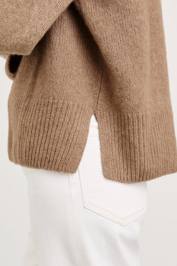 Miranda Long-Sleeve Sweater with a Mock Neck, Side Slits, and Ribbed Trim in Oatmeal Colorway - Side View Featured on Model