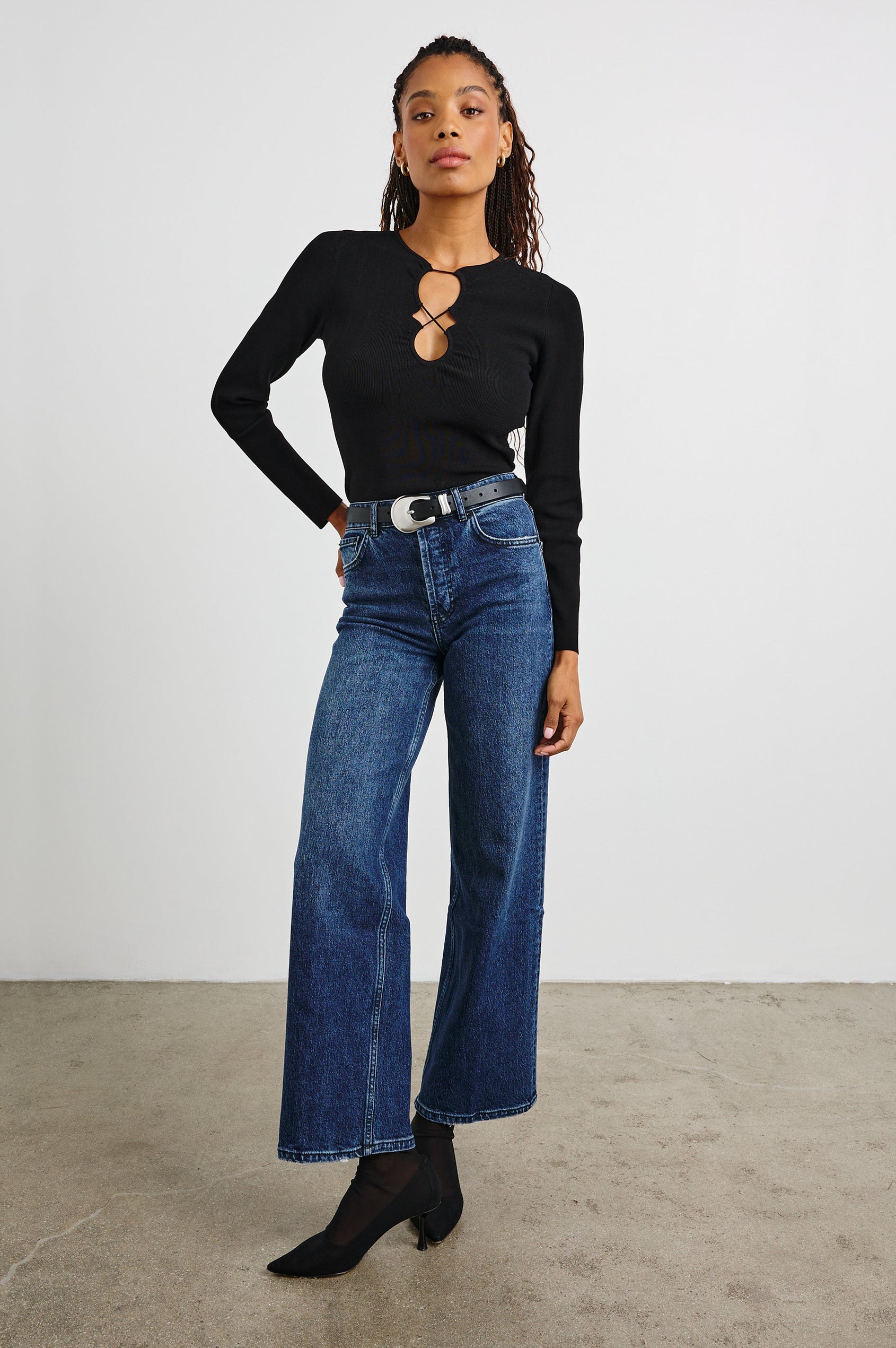 Misa Long-Sleeve Top with a Deep Geometric Cutout in Black Colorway - Front Tucked Full Body View Featured on Model 