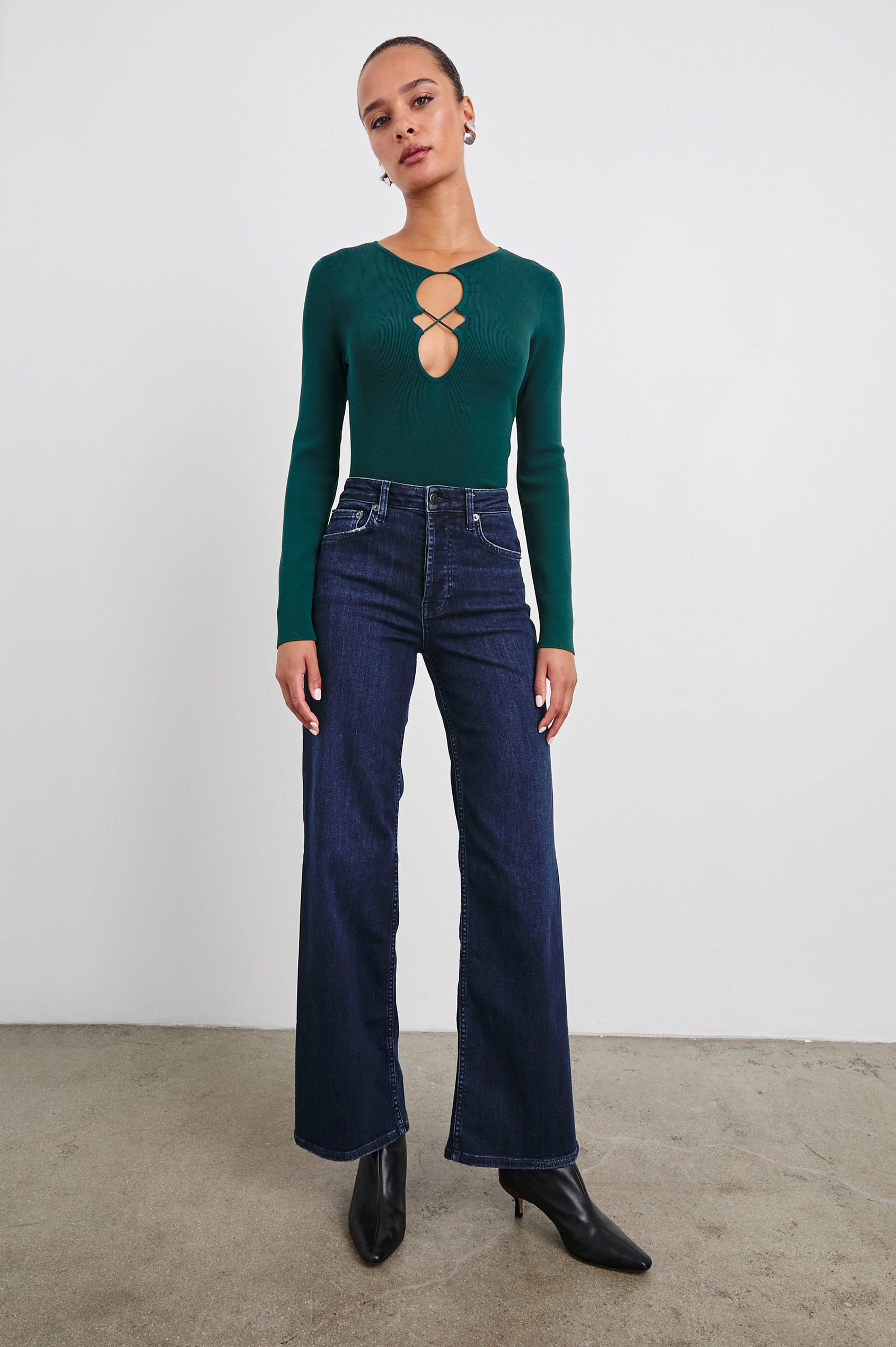 Misa Long-Sleeve Top with a Deep Geometric Cutout in Evergreen Colorway - Front Tucked Full Body View Featured on Model 