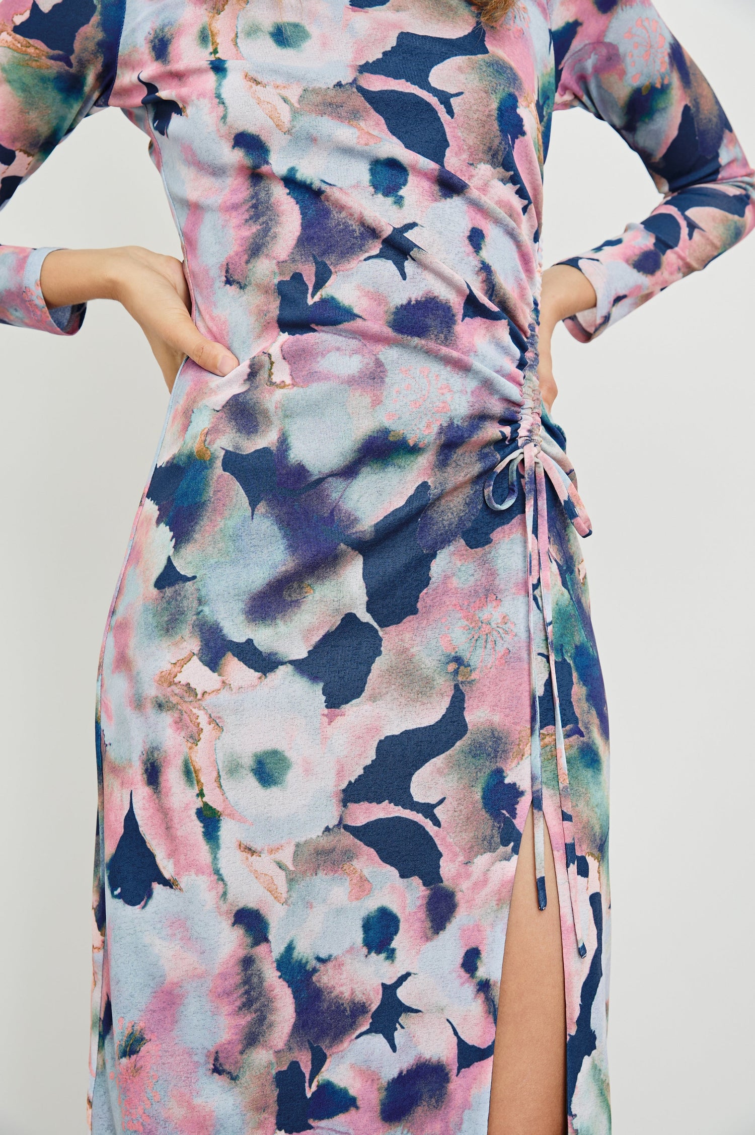 Mona Long Sleeve Midi Dress with a Mock Neck, a Side Slit and Adjustable Ruching along the Left Side with a Drawstring in Midnight Verbena Colorway, Flowers in Pinks, Browns, Greens and Blues on Midnight - Front View Featured on Model 