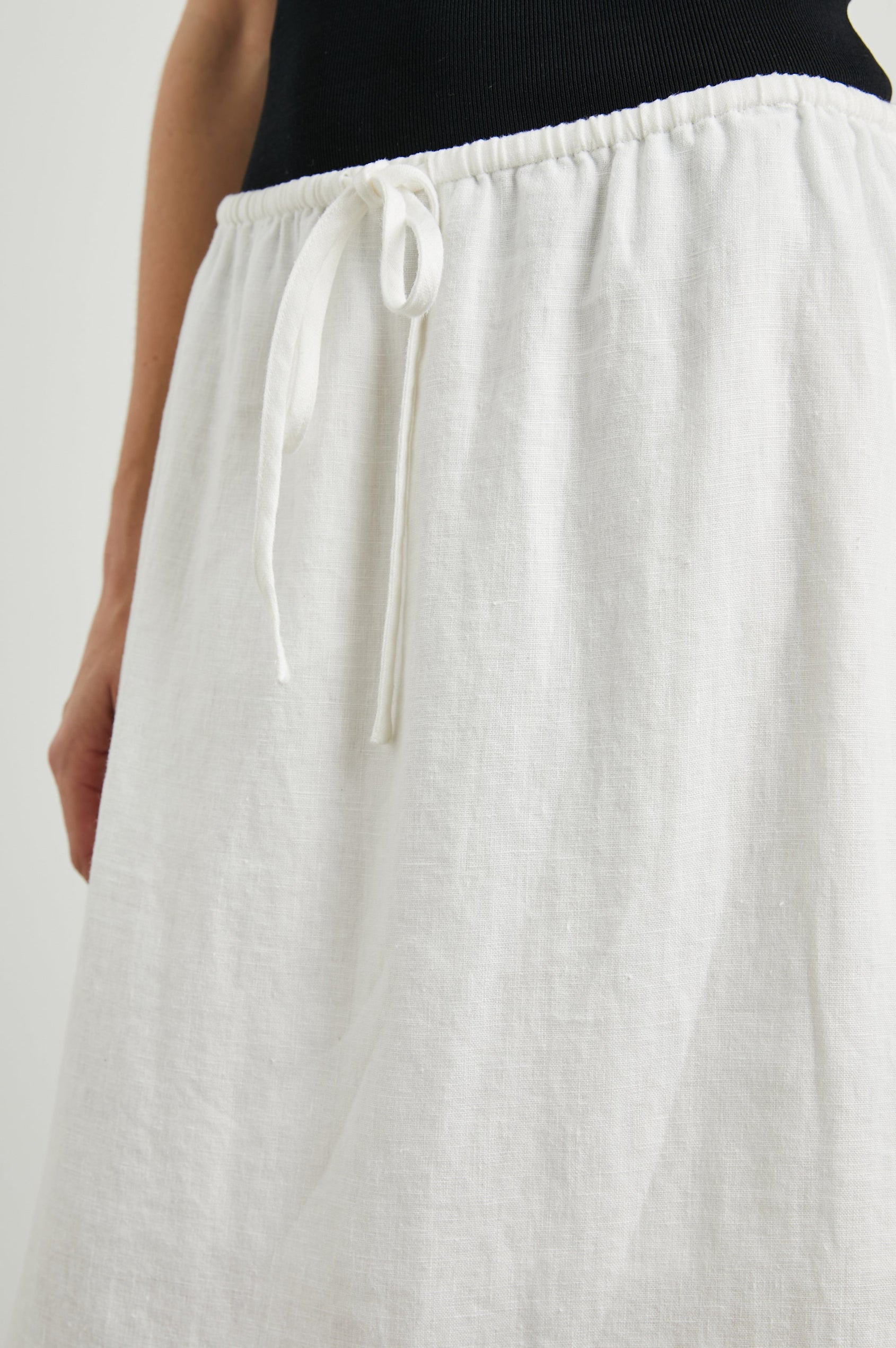 Monet Midi Skirt with Two Side Slits and a Drawstring Waist in White Colorway - Front View Featured on Model 