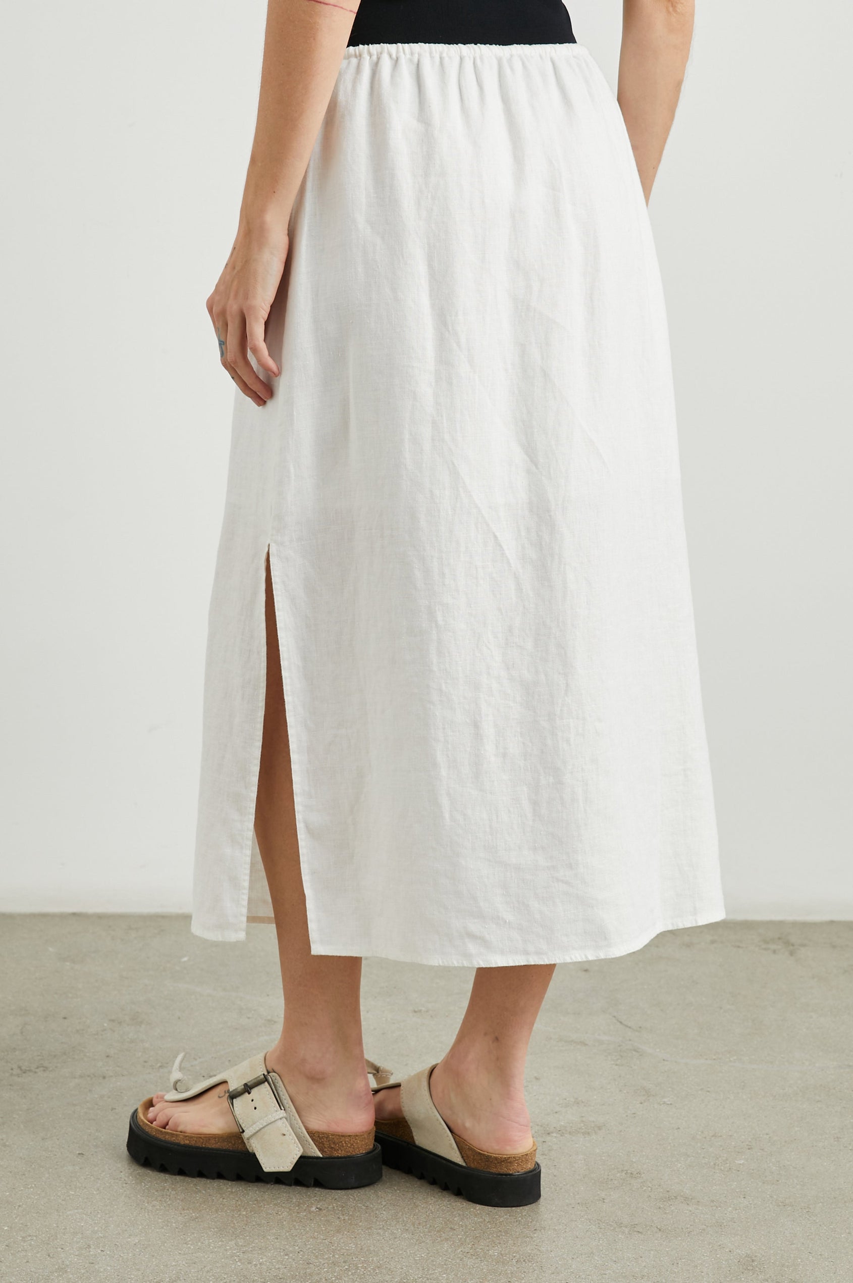 Monet Midi Skirt with Two Side Slits and a Drawstring Waist in White Colorway - Back View Featured on Model 