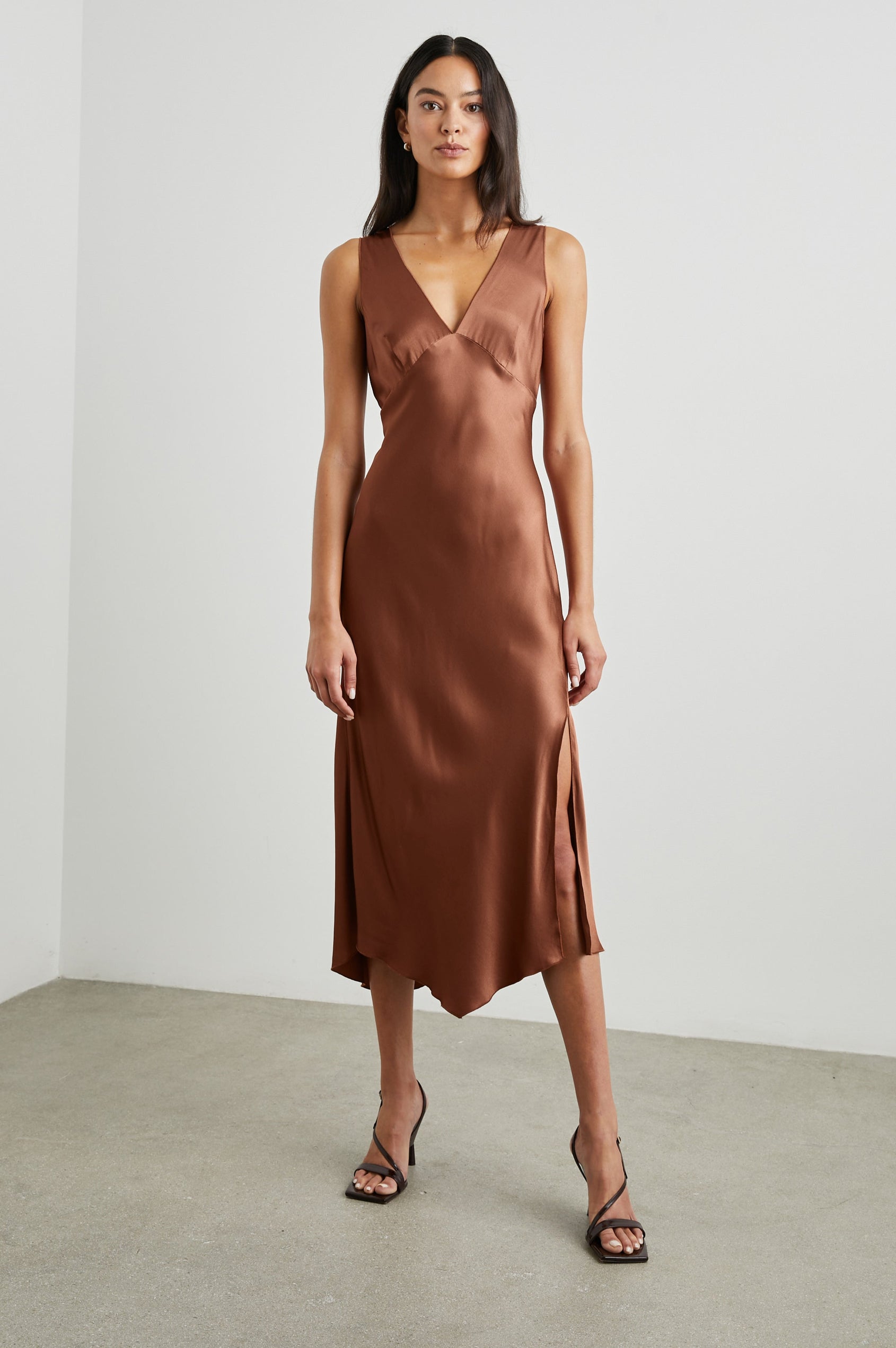 Monique Sleeveless Midi Dress with an Asymmetrical Hem Line, Side Slit, Deep V Neck, and Wide Shoulder Straps in Cedar Colorway - Front Full Body View Featured on Model
