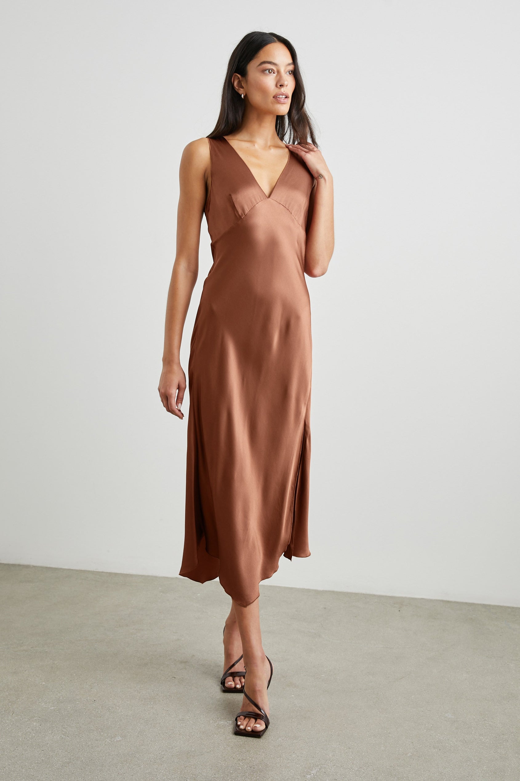 Monique Sleeveless Midi Dress with an Asymmetrical Hem Line, Side Slit, Deep V Neck, and Wide Shoulder Straps in Cedar Colorway - Front Full Body View Featured on Model