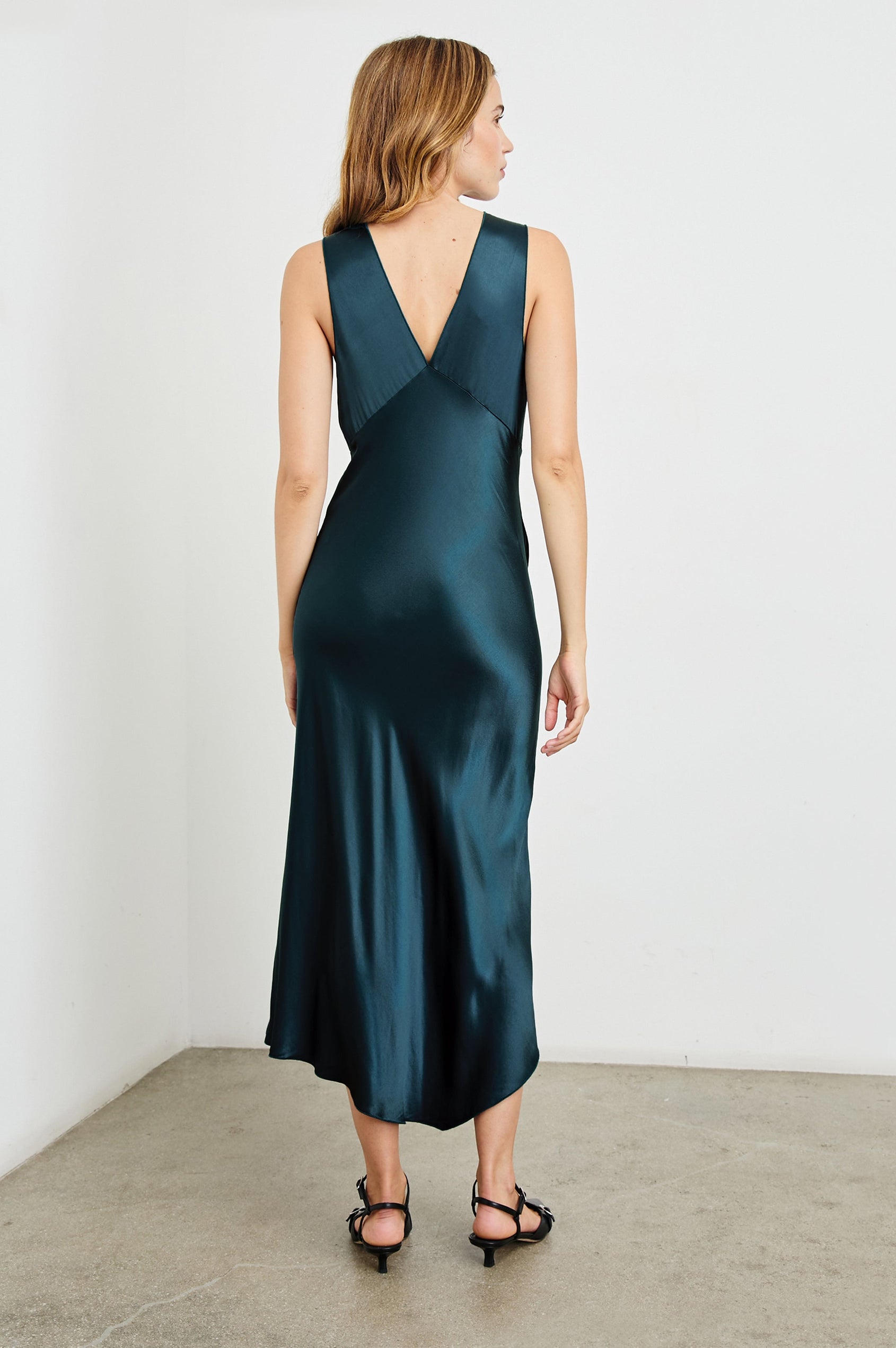 Monique Sleeveless Midi Dress with an Asymmetrical Hem Line, Side Slit, Deep V Neck, and Wide Shoulder Straps in Deep Sea Colorway - Back Full Body View Featured on Model