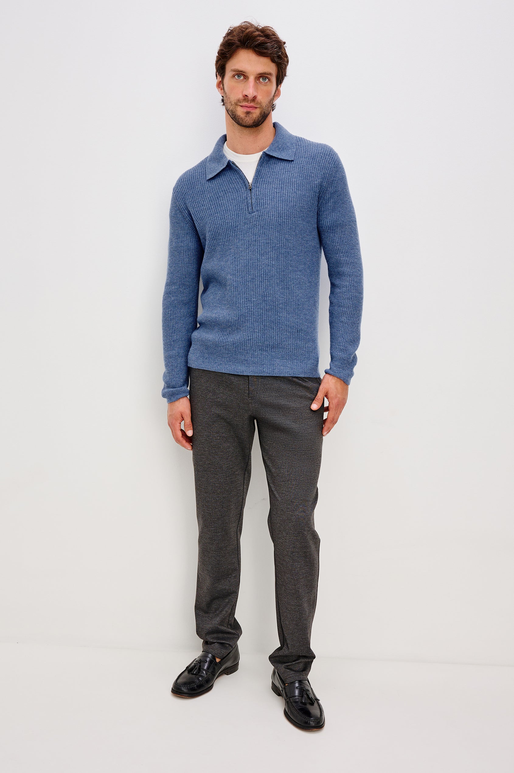 Monty is a collared quarter-zip long sleeved sweater in Cerulean Melange colorway. Front full body view featured on model.