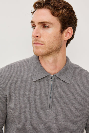 Monty is a collared quarter-zip long sleeved sweater in Finch colorway. Front detail view featured on model.