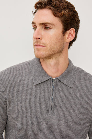 Monty is a collared quarter-zip long sleeved sweater in Finch colorway. Front detail view featured on model.