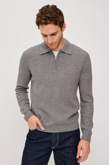 Monty is a collared quarter-zip long sleeved sweater in Finch colorway. Front view featured on the model.
