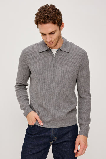 Monty is a collared quarter-zip long sleeved sweater in Finch colorway. Front view featured on the model.