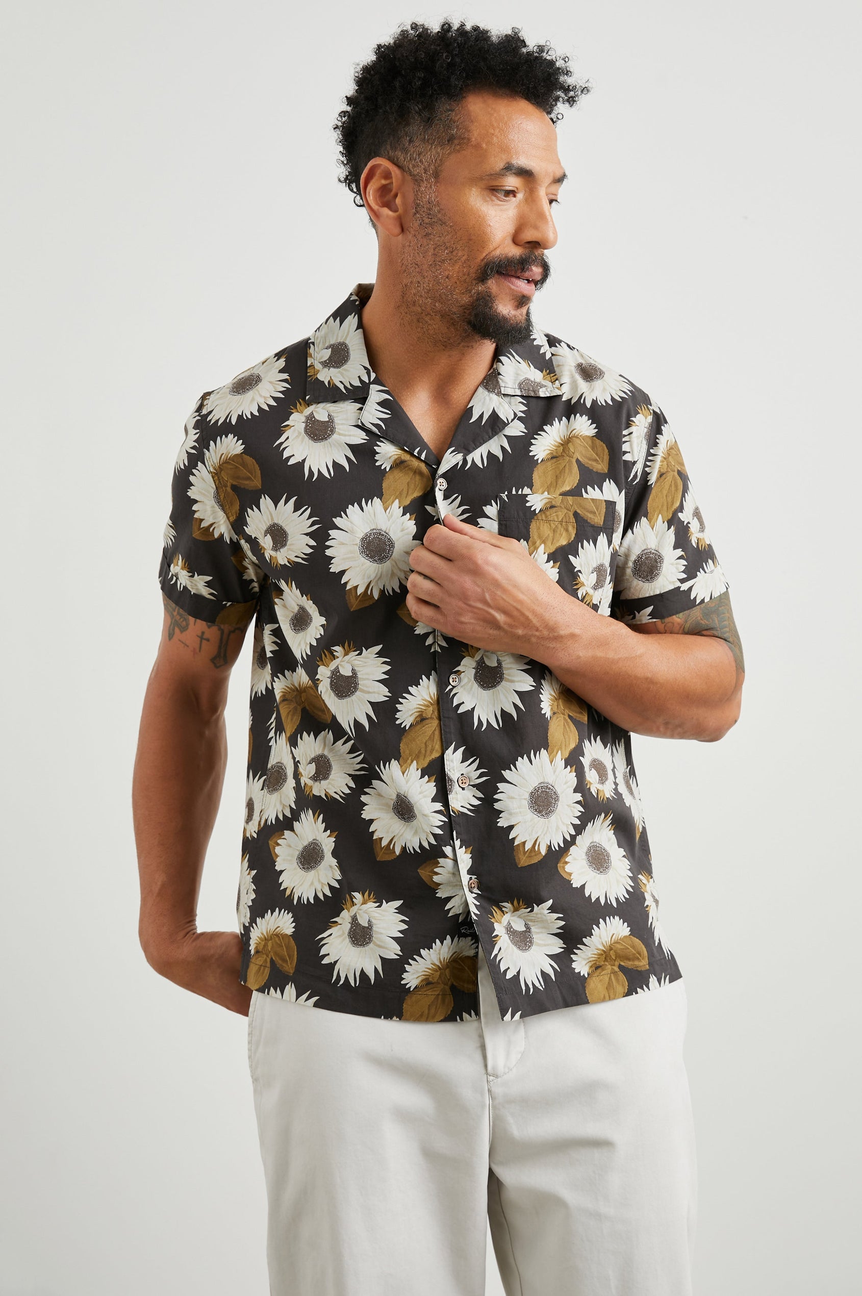 Moreno Short Sleeve Button Up with a Chest Patch Pocket in Sunflower Twirl Bark Colorway, White Sunflowers and Brown Leaves on Black  - Front View Featured on Model