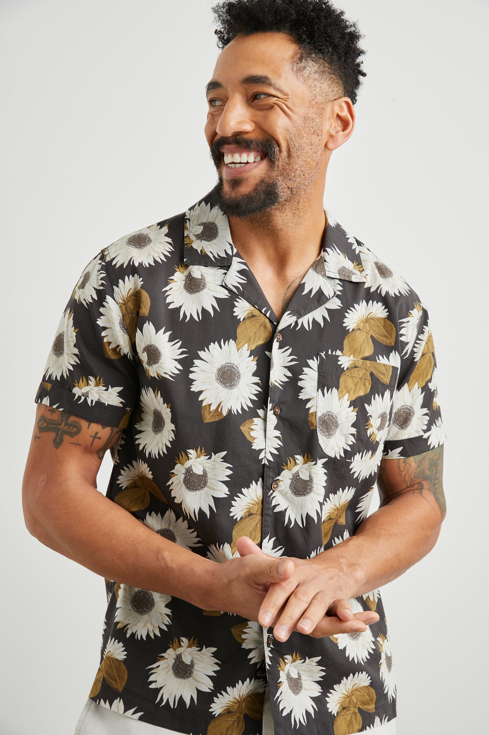Moreno Short Sleeve Button Up with a Chest Patch Pocket in Sunflower Twirl Bark Colorway, White Sunflowers and Brown Leaves on Black  - Front View Featured on Model
