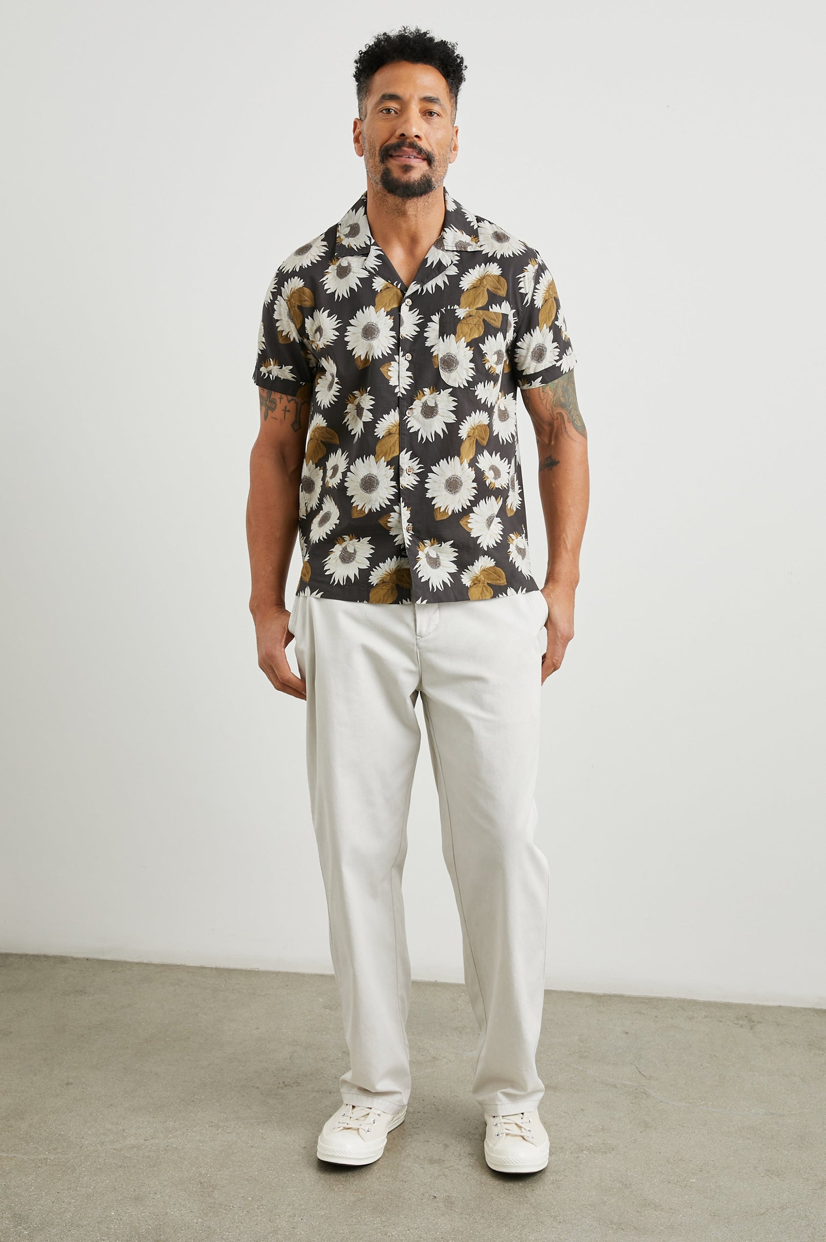 Moreno Short Sleeve Button Up with a Chest Patch Pocket in Sunflower Twirl Bark Colorway, White Sunflowers and Brown Leaves on Black  - Front Full Body View Featured on Model