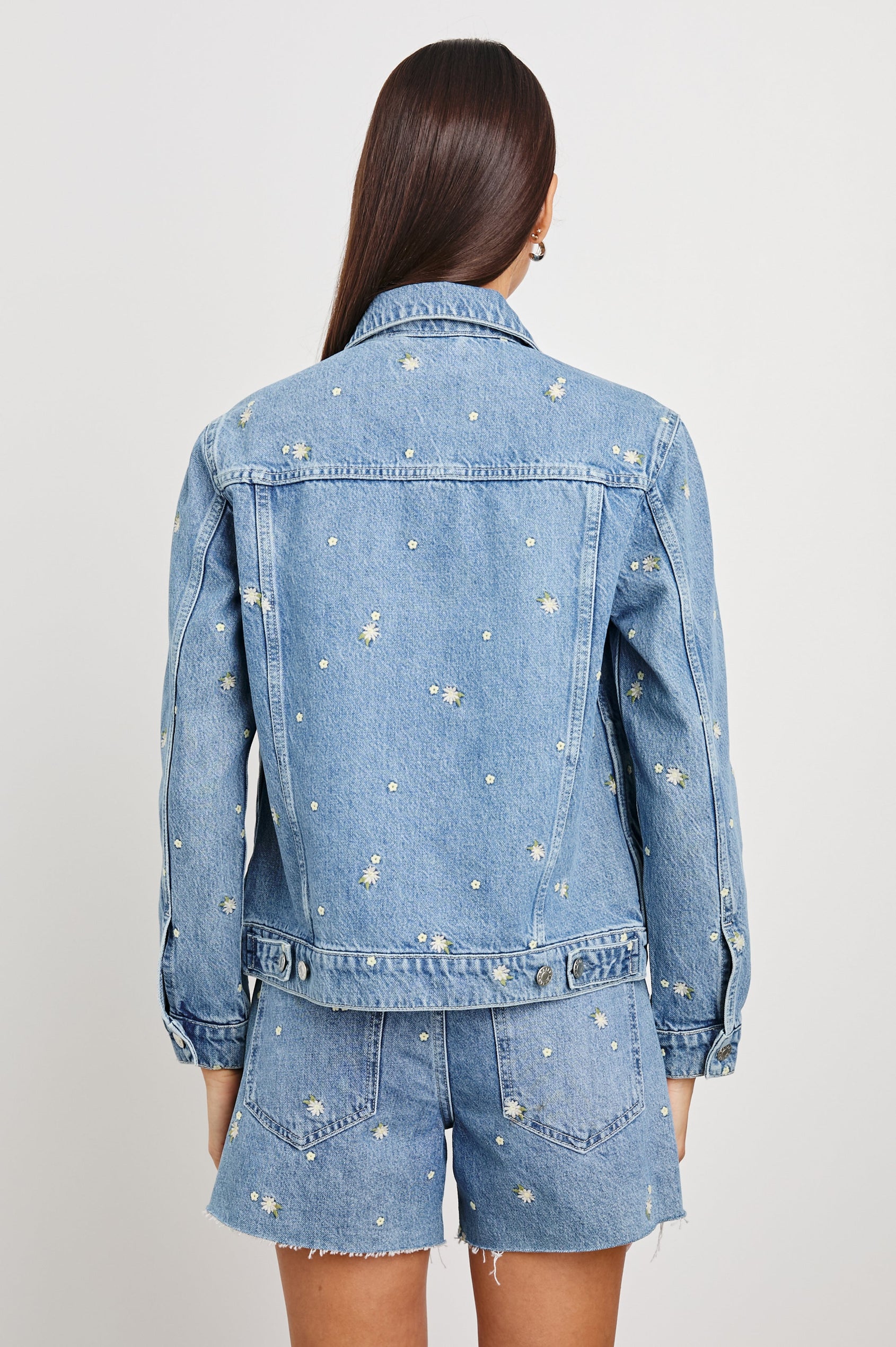 Mulholland Indigo Trucker Style Denim Jacket with 2 Front Pockets, Front Buttons, and Daisy Embroidery Details - Back View on Model Showing Embroidery Details