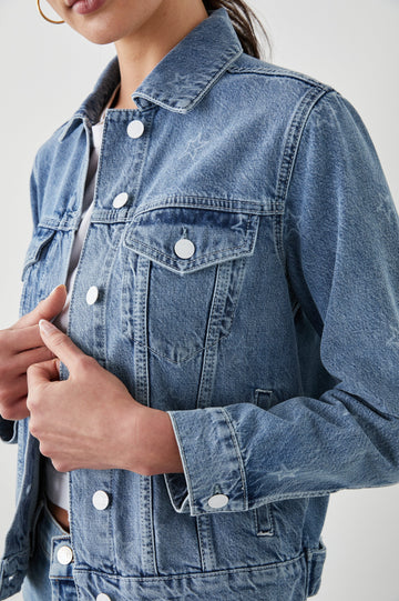 Mulholland Denim Jacket with Button Closure, Two Chest Button Flap Pockets, Two Front Pockets, Adjustable Button Straps on Hem in Lady Liberty Colorway, with White Stars - Side View Featured on Model  