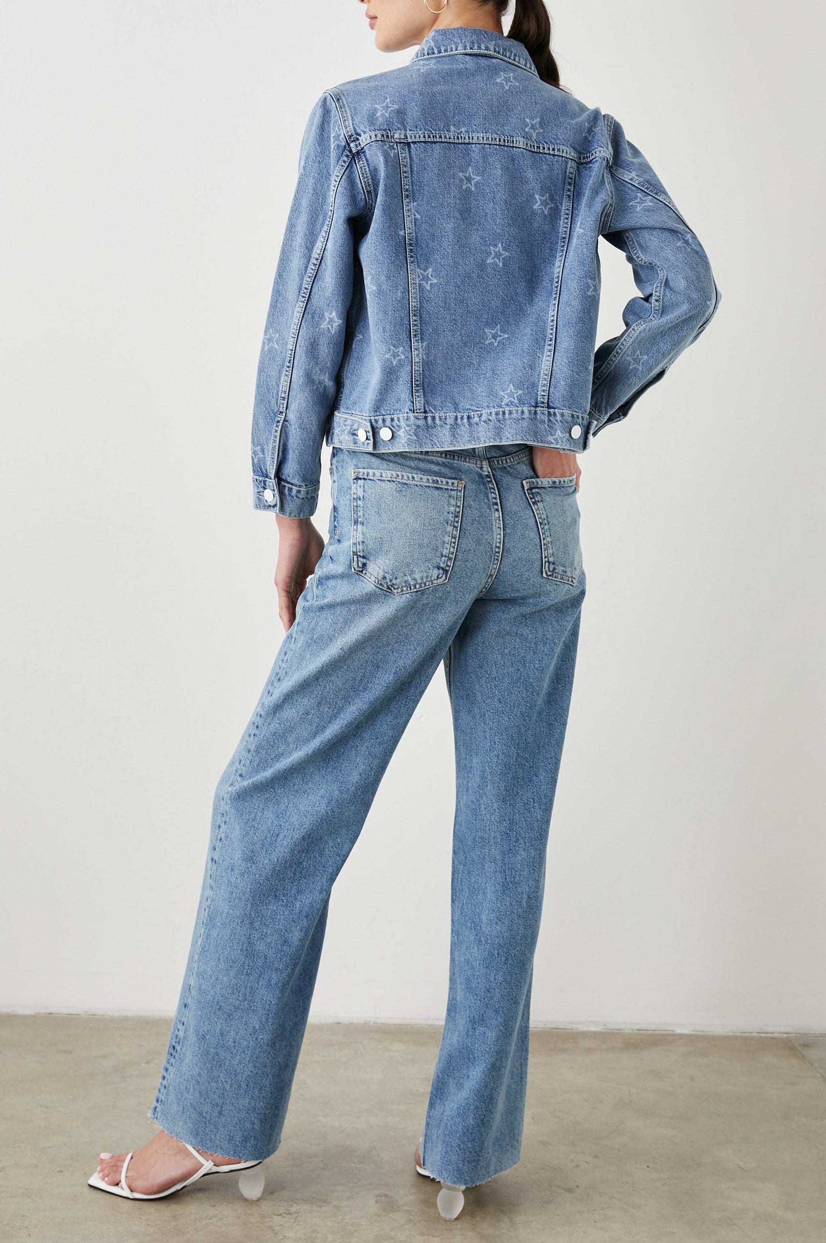 Mulholland Denim Jacket with Button Closure, Two Chest Button Flap Pockets, Two Front Pockets, Adjustable Button Straps on Hem in Lady Liberty Colorway, with White Stars - Back Full Body View Featured on Model  