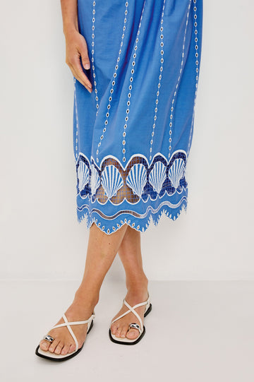 Murano Midi Tank Dress with Spaghetti Straps, Gathered Elastic Waistband, Sea Shell Embroidery and Scalloped Hem in French Blue Colorway. Close up of details Shown on Model.