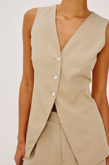 Mylah Vest in Viscose Suiting With V-Neckline, Front Buttons, and Slightly-Loose Fit Tapered at Waist in Almond Colorway - Upper Body Front View Featured on Model