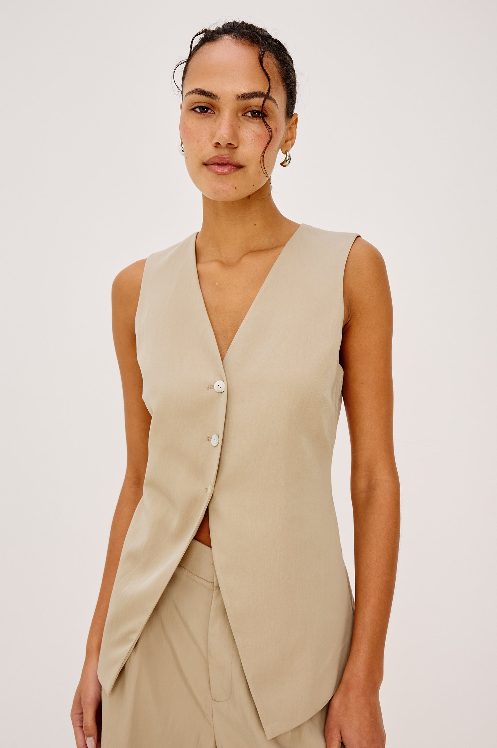 Mylah Vest in Viscose Suiting With V-Neckline, Front Buttons, and Slightly-Loose Fit Tapered at Waist in Almond Colorway - Upper Body Front View Featured on Model