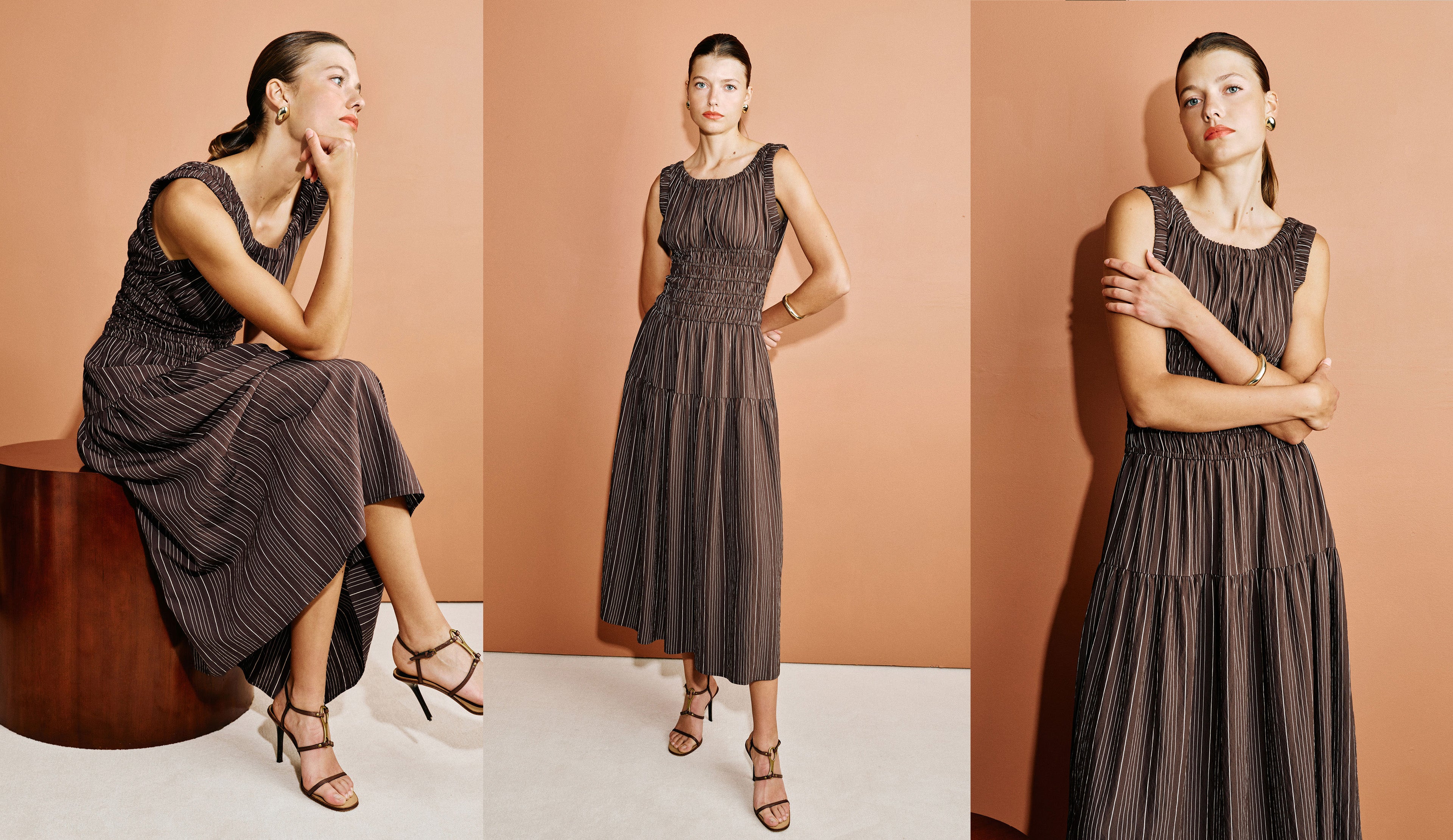 Woman wearing a brown striped midi dress with heels against an orange background.