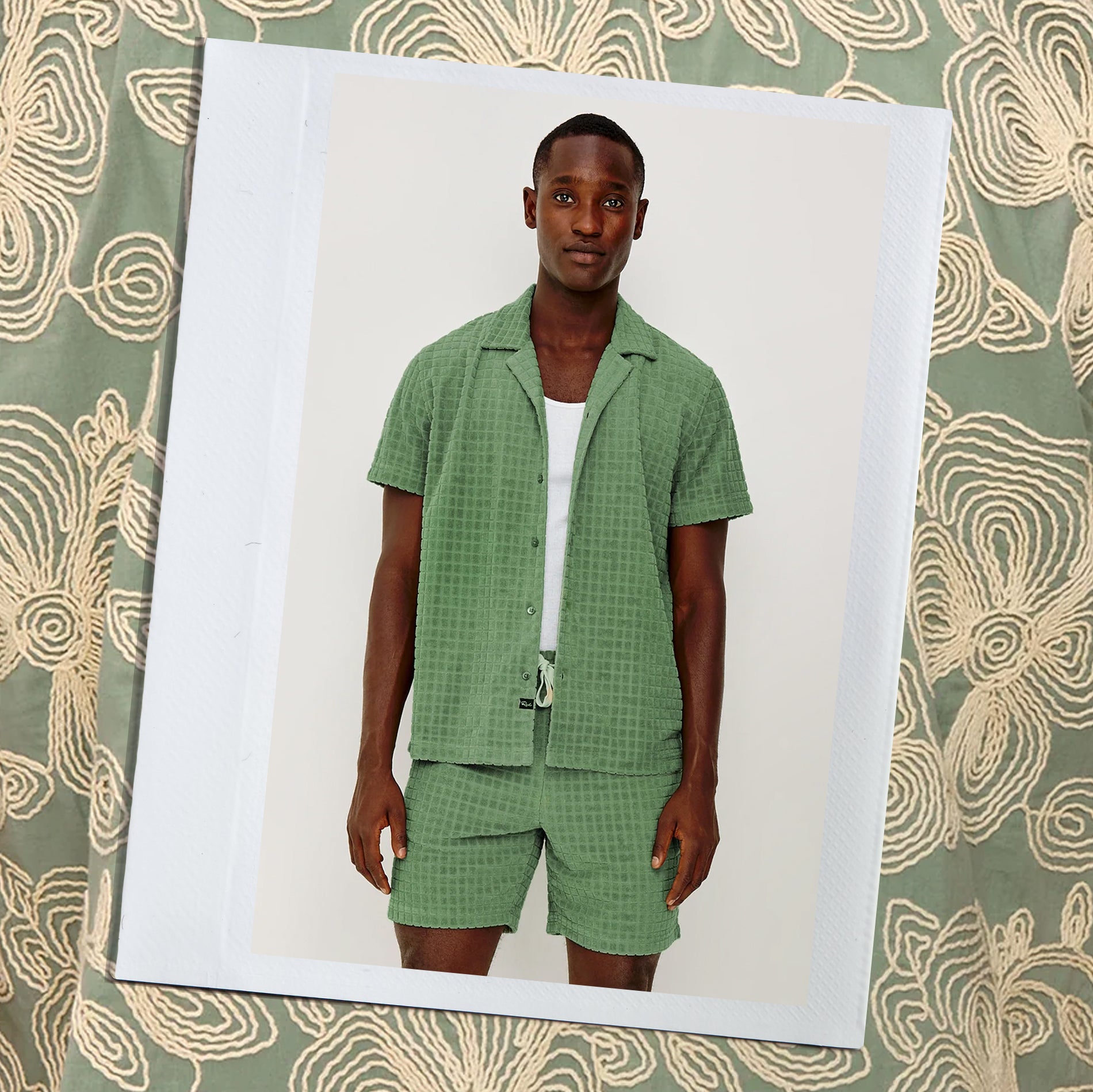 Man wearing a green checkered outfit on a patterned background