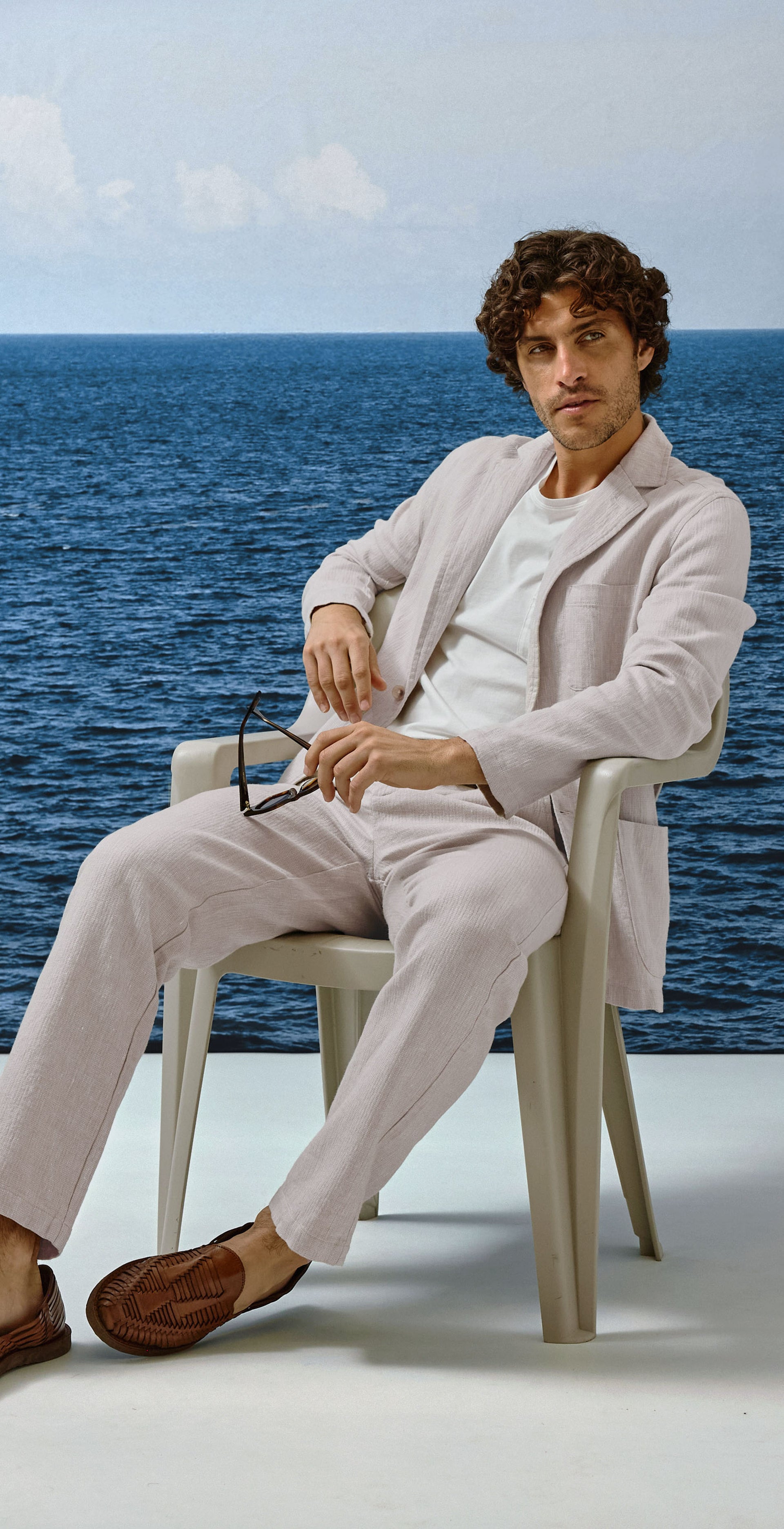 Man sitting on a chair by the ocean